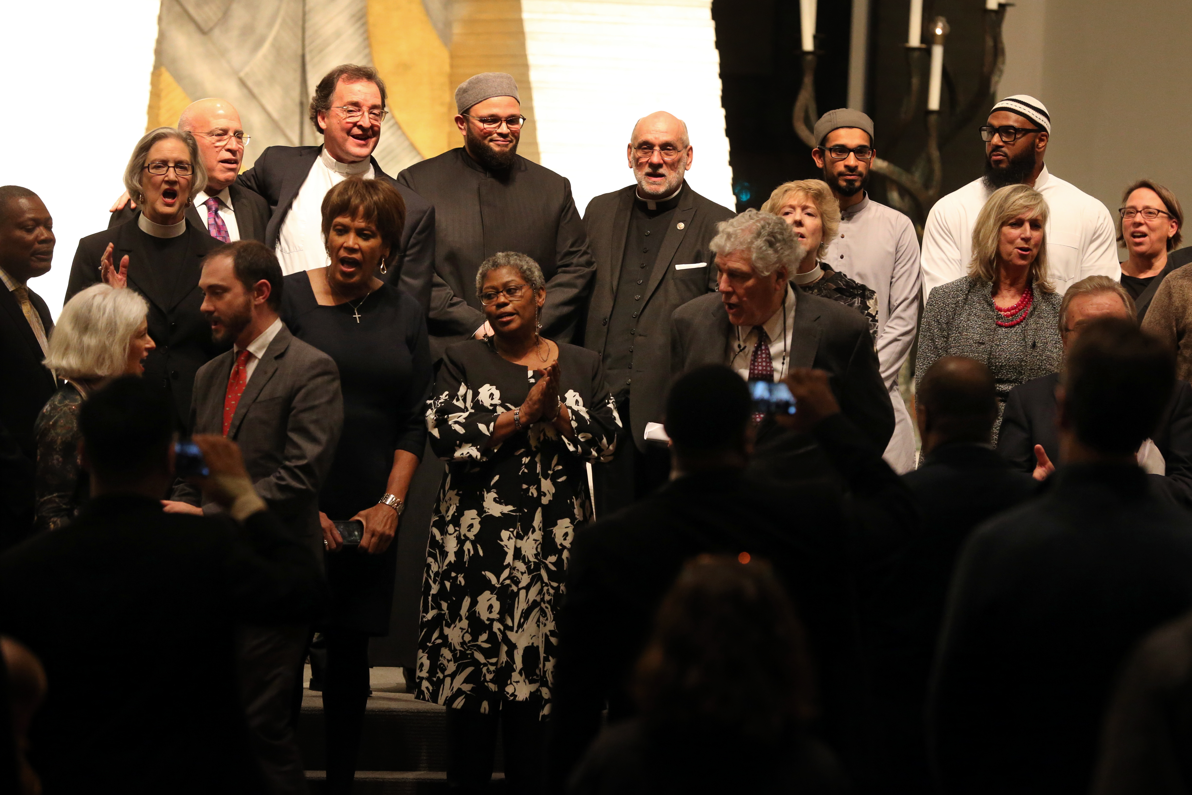 Two dozen leaders of various faiths joined Temple Israel rabbis on stage for moments of prayer on Friday night.