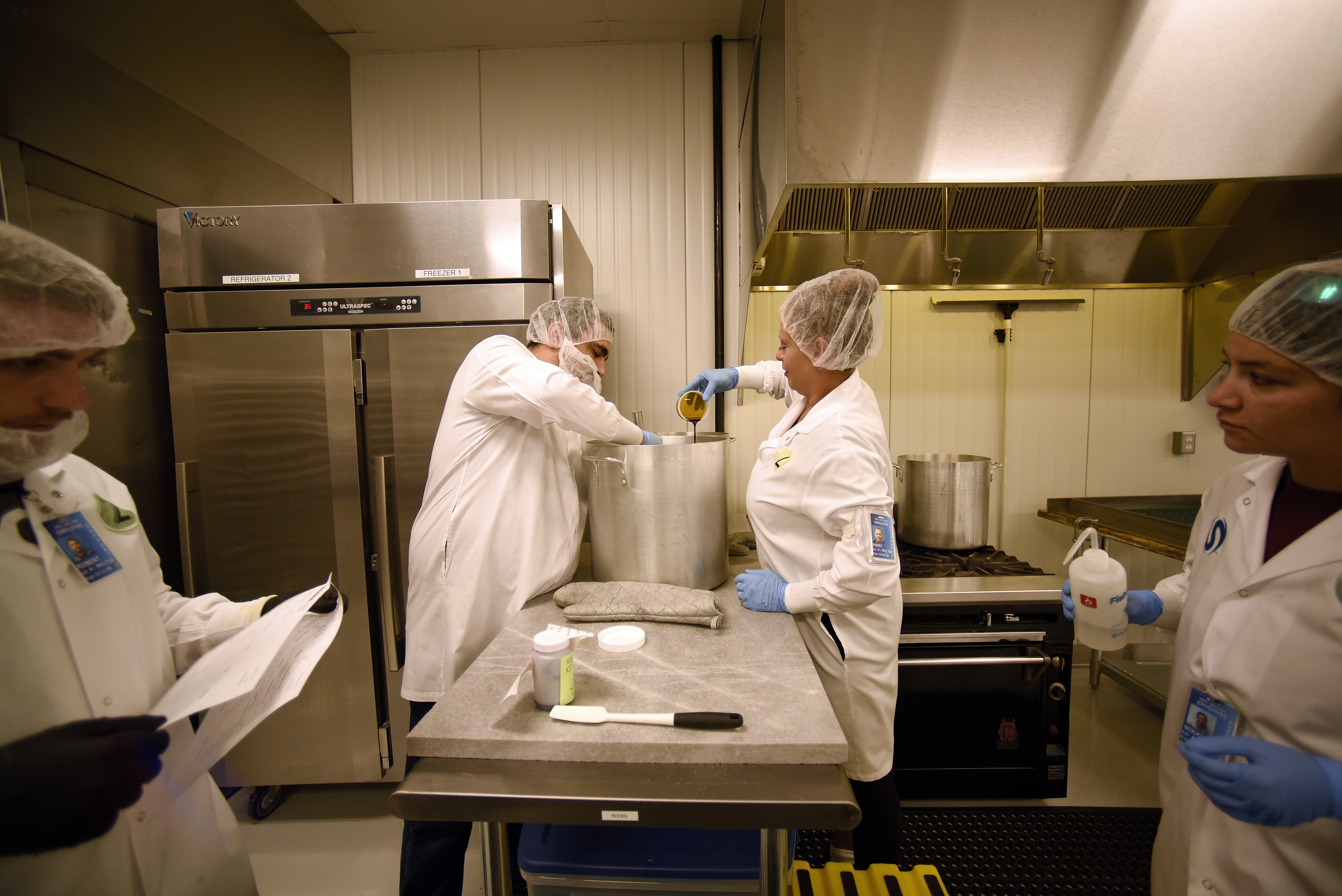 Production lead John Decker stirred as Mary Sanchez added THC to the Zoots candy nuggets mix at the Zoots marijuana edibles production facility in Denver.
