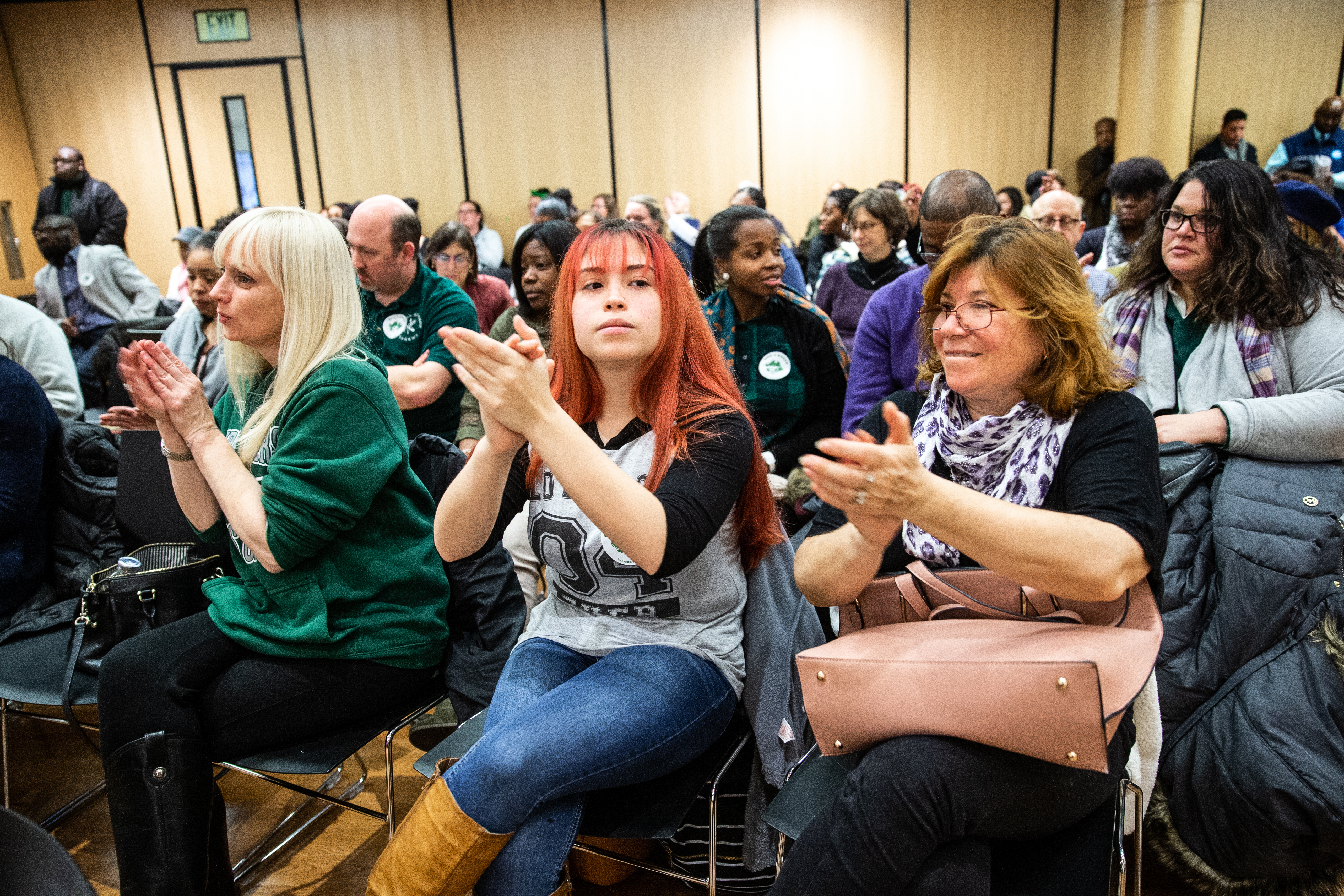 Urban Science Academy teacher Amy Eisenschmidt, West Roxbury Academy junior Catari Giglio, 16, and her mother Ingrid Morales applauded for no school closures during a Boston School Committee meeting held at the Bruce C. Bolling Municipal Building in Roxbury.