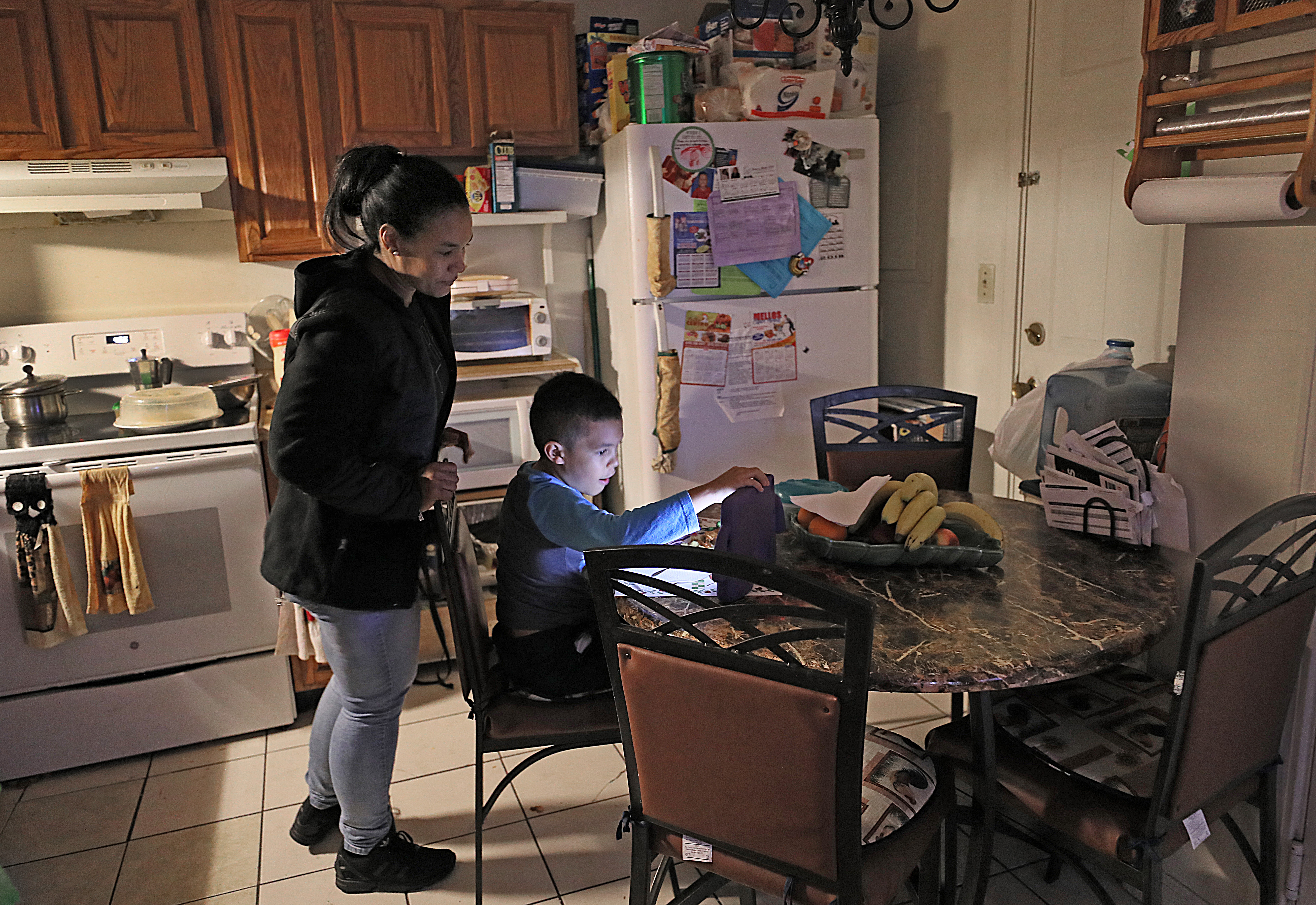 Elizabeth Bautista set her son up with a tablet before heading to a business class in the evening.