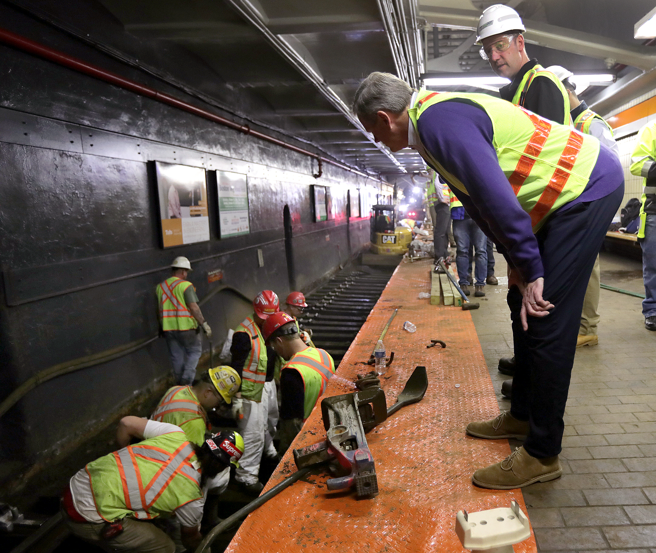 Governor Charlie Baker watched as workers replaced tracks on the Orange Line. The governor filed an $18 billion transportation bond bill earlier this year.