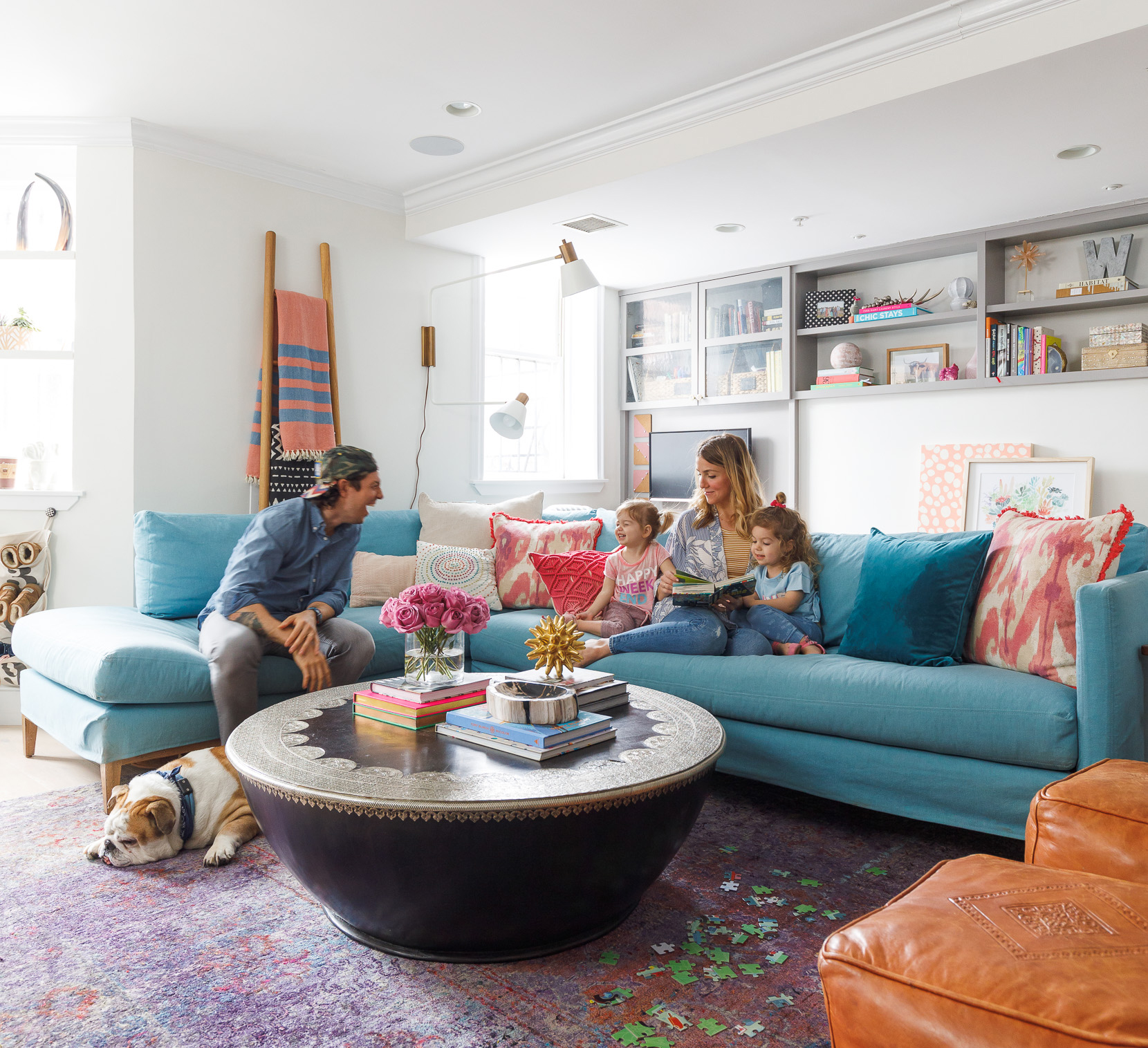 The Wyss family and their bulldog, Bubby, take a break in the living room. Jon’s desk is built into the back wall, painted pale gray to echo the veining in the kitchen countertop.