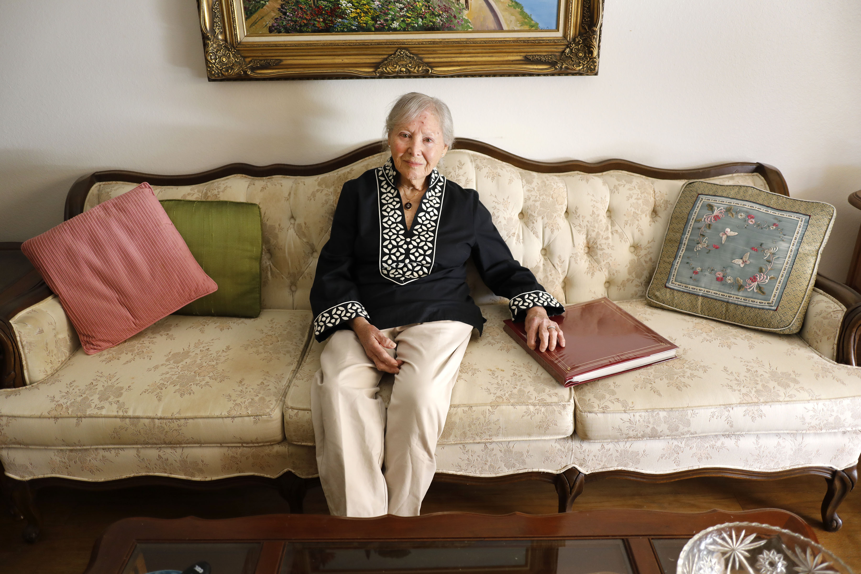 Pauline Herzek, pictured at her San Diego home with the family album, is planning to move to the Boston area.