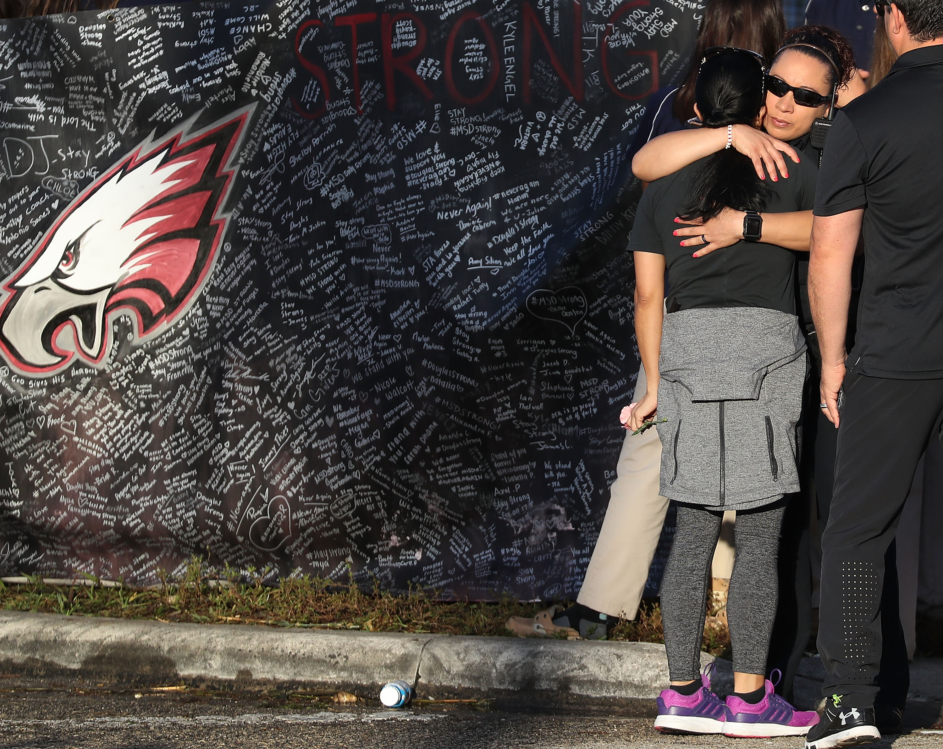 People hugged each other as students arrive at Marjory Stoneman Douglas High School for the first time since the shooting.