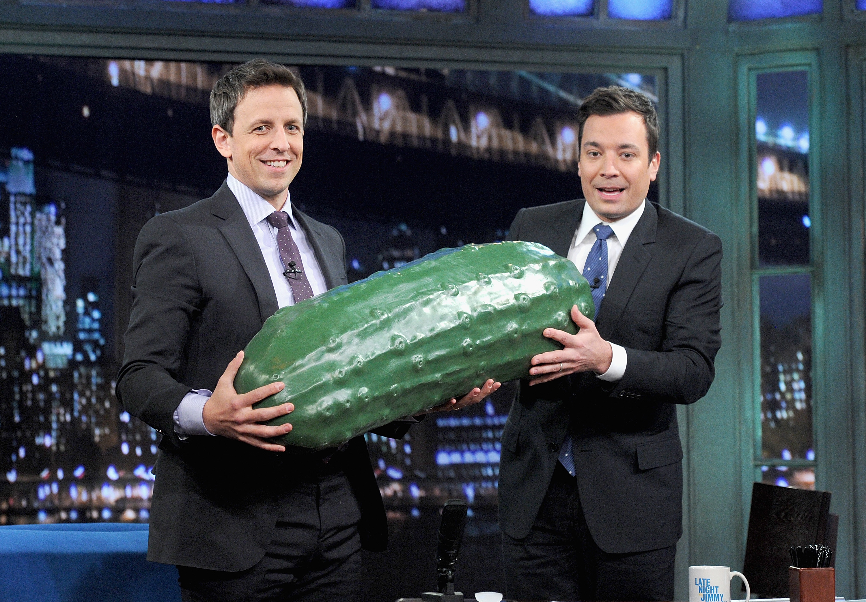 Seth Meyers receiving the ceremonial big pickle in January from Jimmy Fallon when he was named new host of “Late Night.”