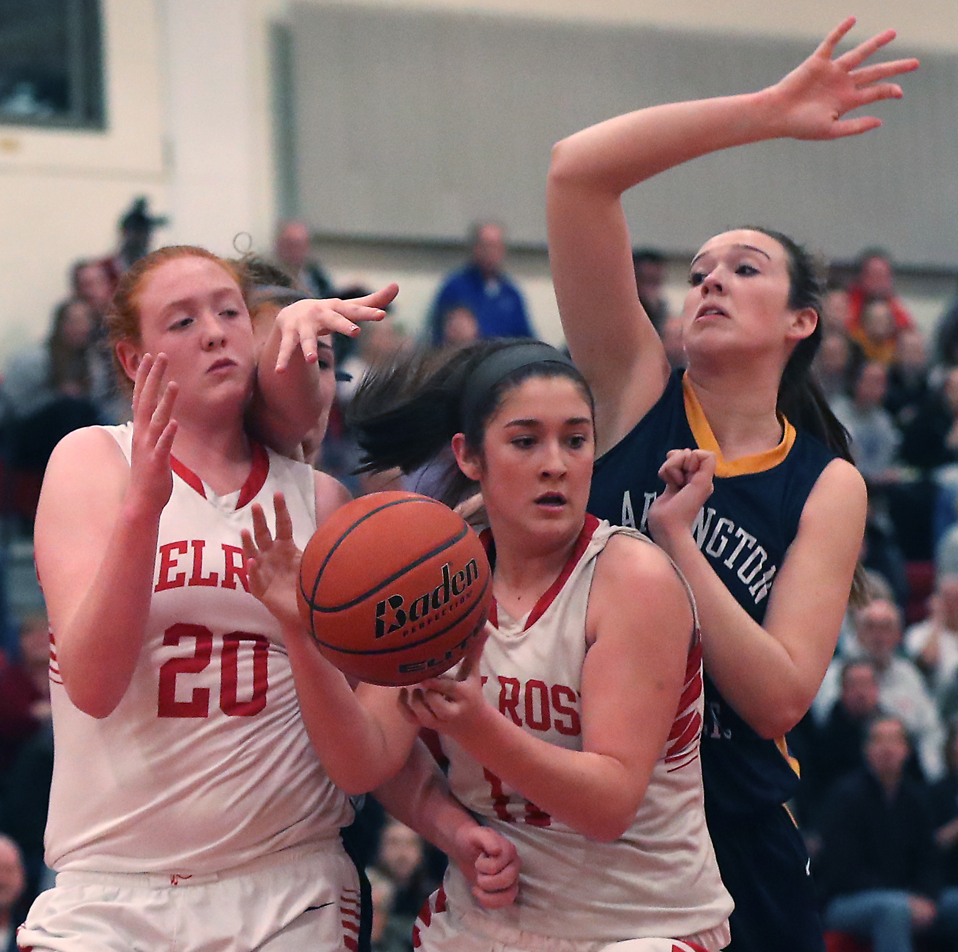 Melrose’s Peri MacDonald grabs an offensive rebound in front of teammate Samantha Dewey and Arlington Catholic’s Kristien O'Keefe during the first quarter.