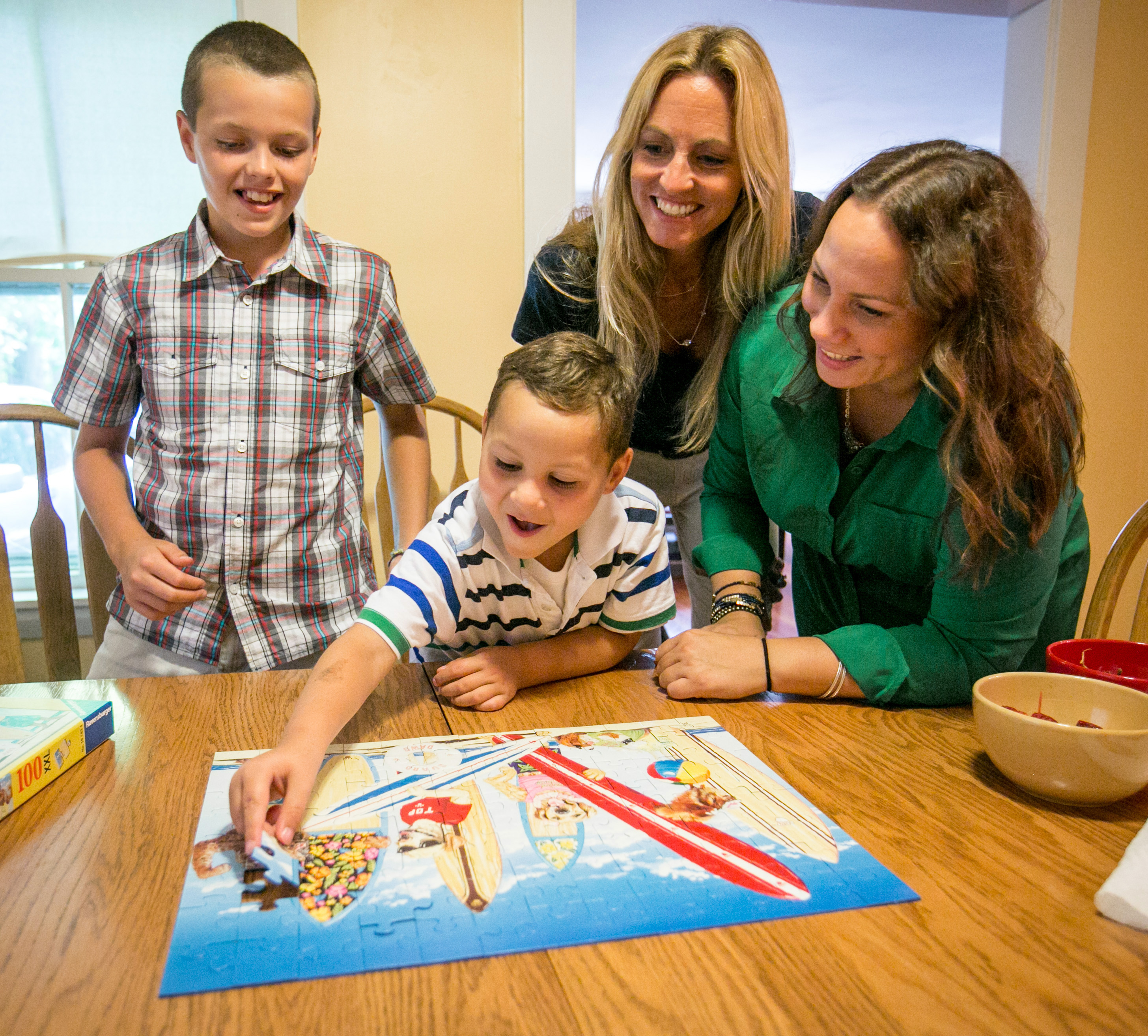 Drew Tardif, 10, worked on a puzzle with Mikalo Glennon, 7, and his mother Raquel Rohlfing.