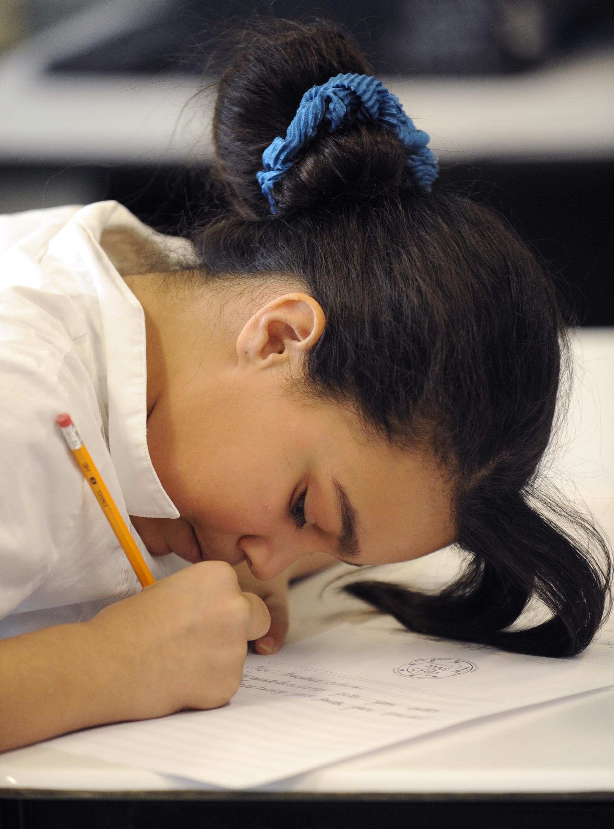 Malika Jusino, 10, uses an up close approach to her writing.