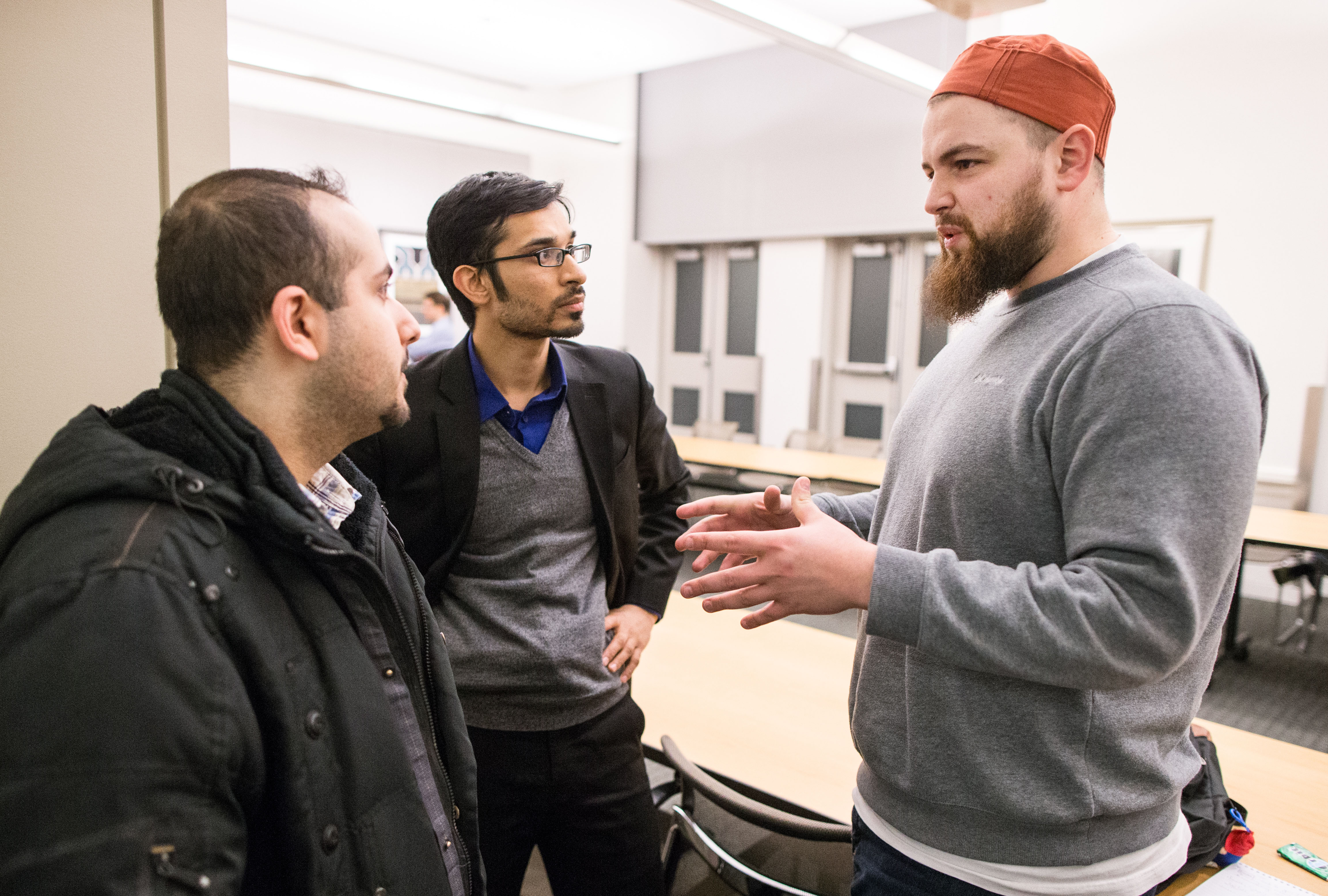From left, Anas Al Bastami and Yusufi Vali speak with AbdelRahman Murphy at MIT.
