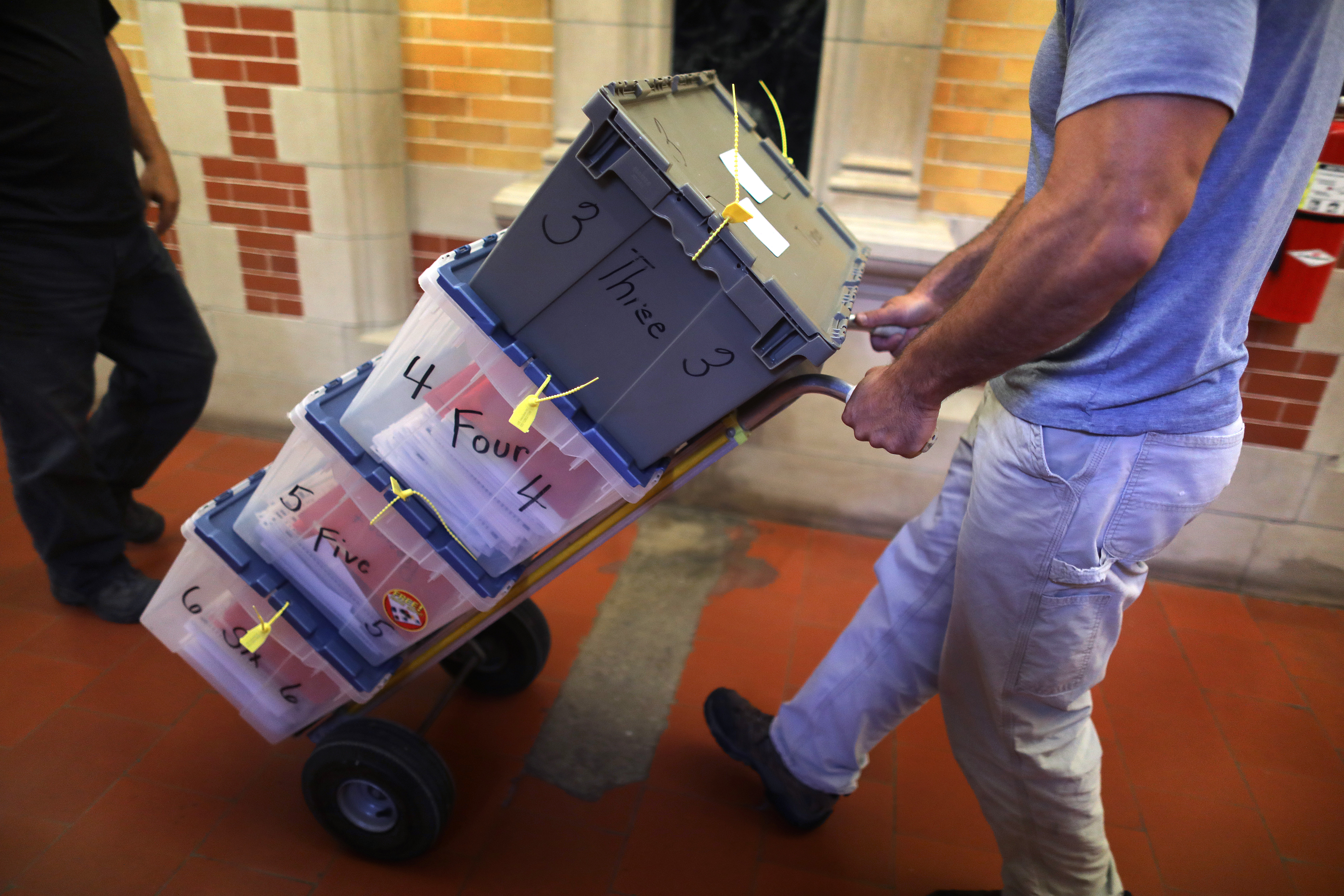 The first load of ballots is rolled down the hall from the city clerk's vault.