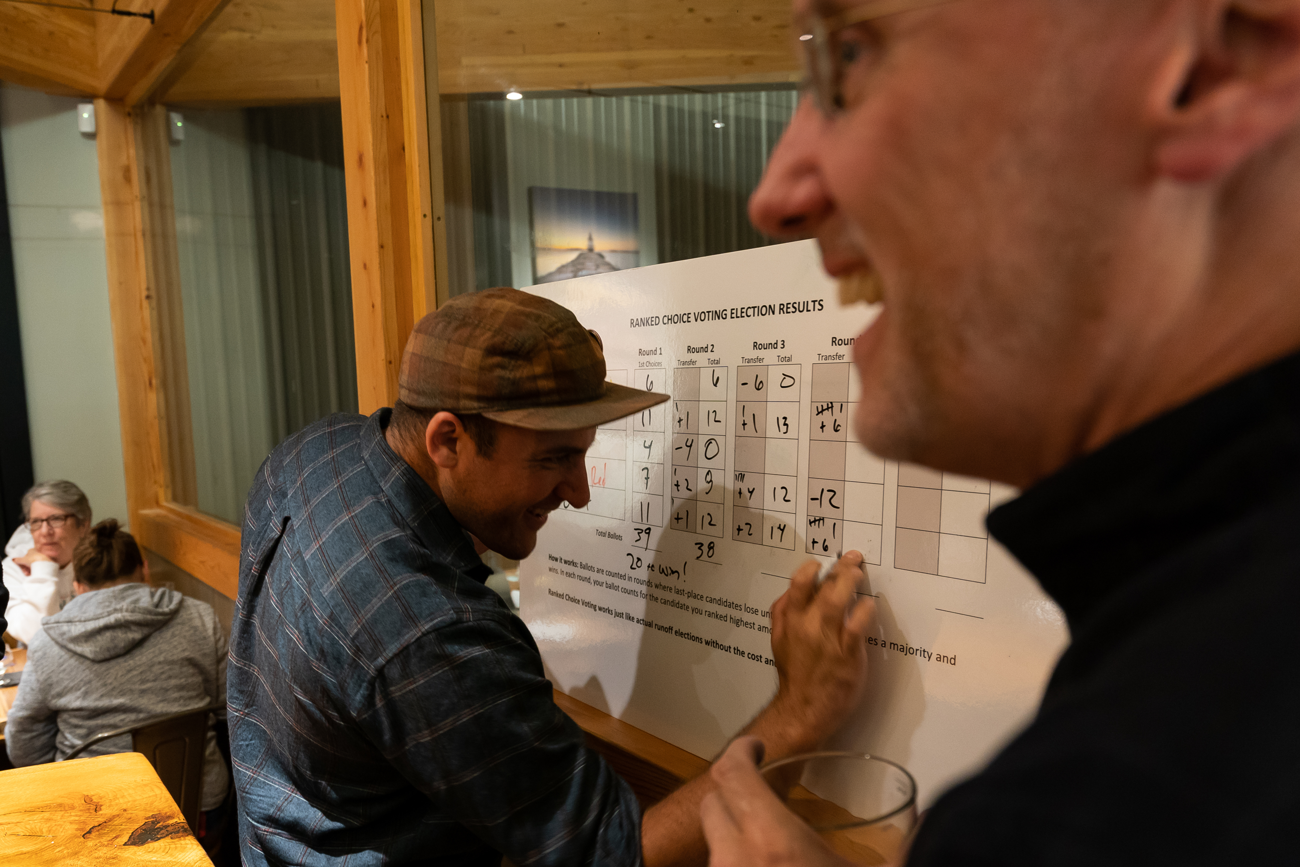 Beer elections have been part of the process of showing Mainers how ranked-choice voting works: people rank their preferences and if their first choice doesn’t win, their second choice might. Grayson Lookner (above), events coordinator for the Committee for Ranked Choice Voting, counts votes at an event at Scarborough’s Nonesuch River Brewing.