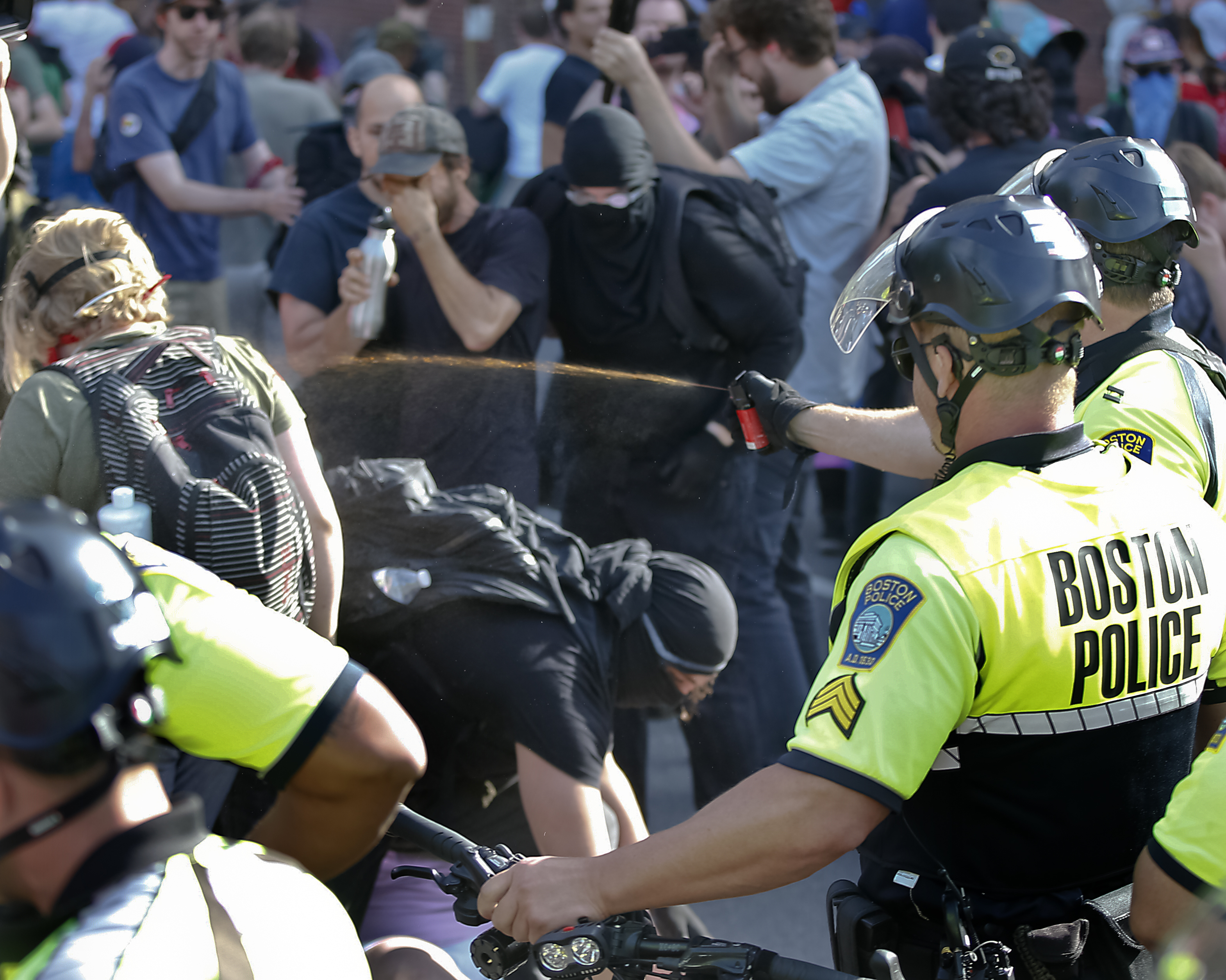Police use pepper spray on protesters outside the Straight Pride rally at City Hall Plaza.