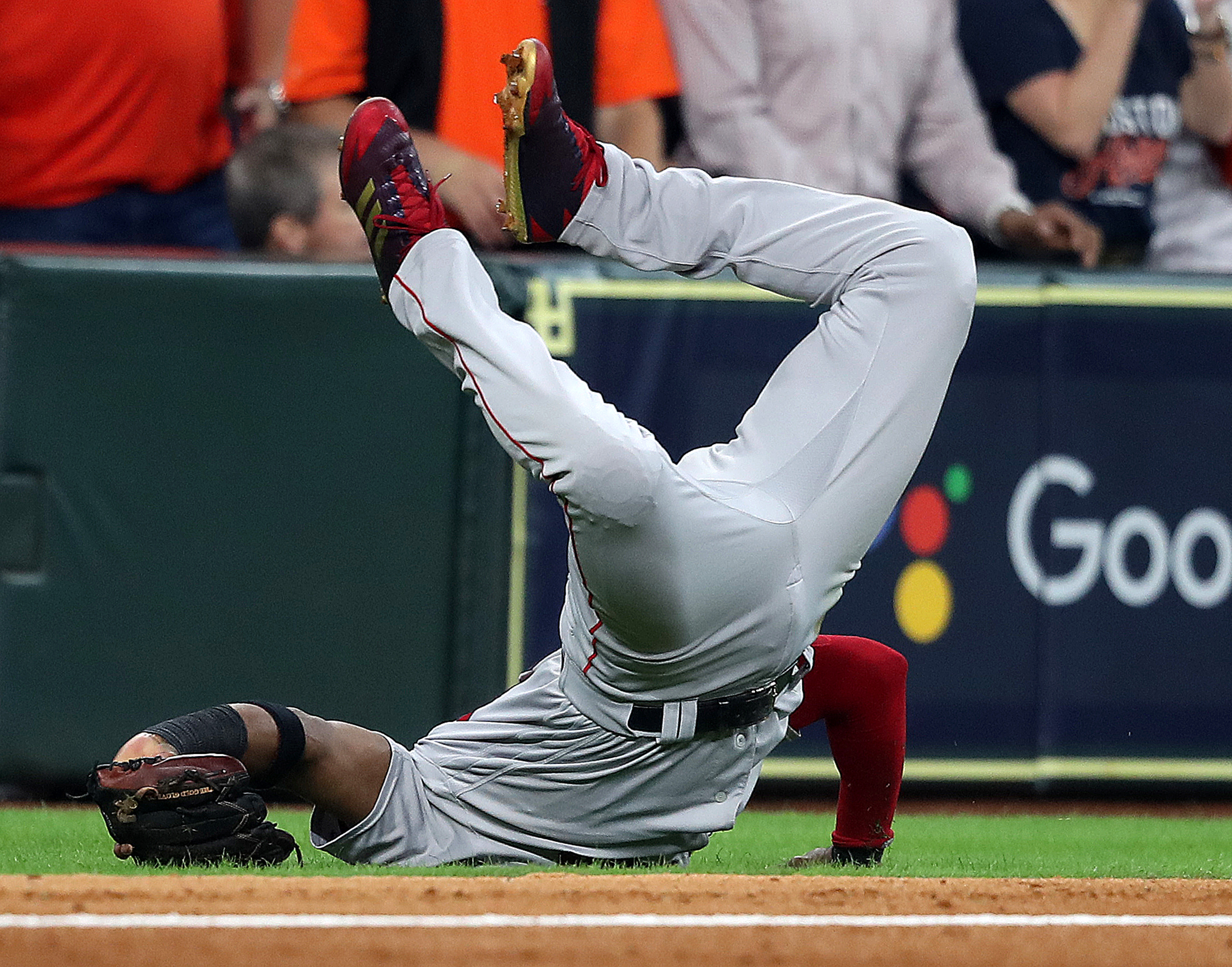 Red Sox third baseman Eduardo Nunez flipped over after diving for a foul ball in the first inning.