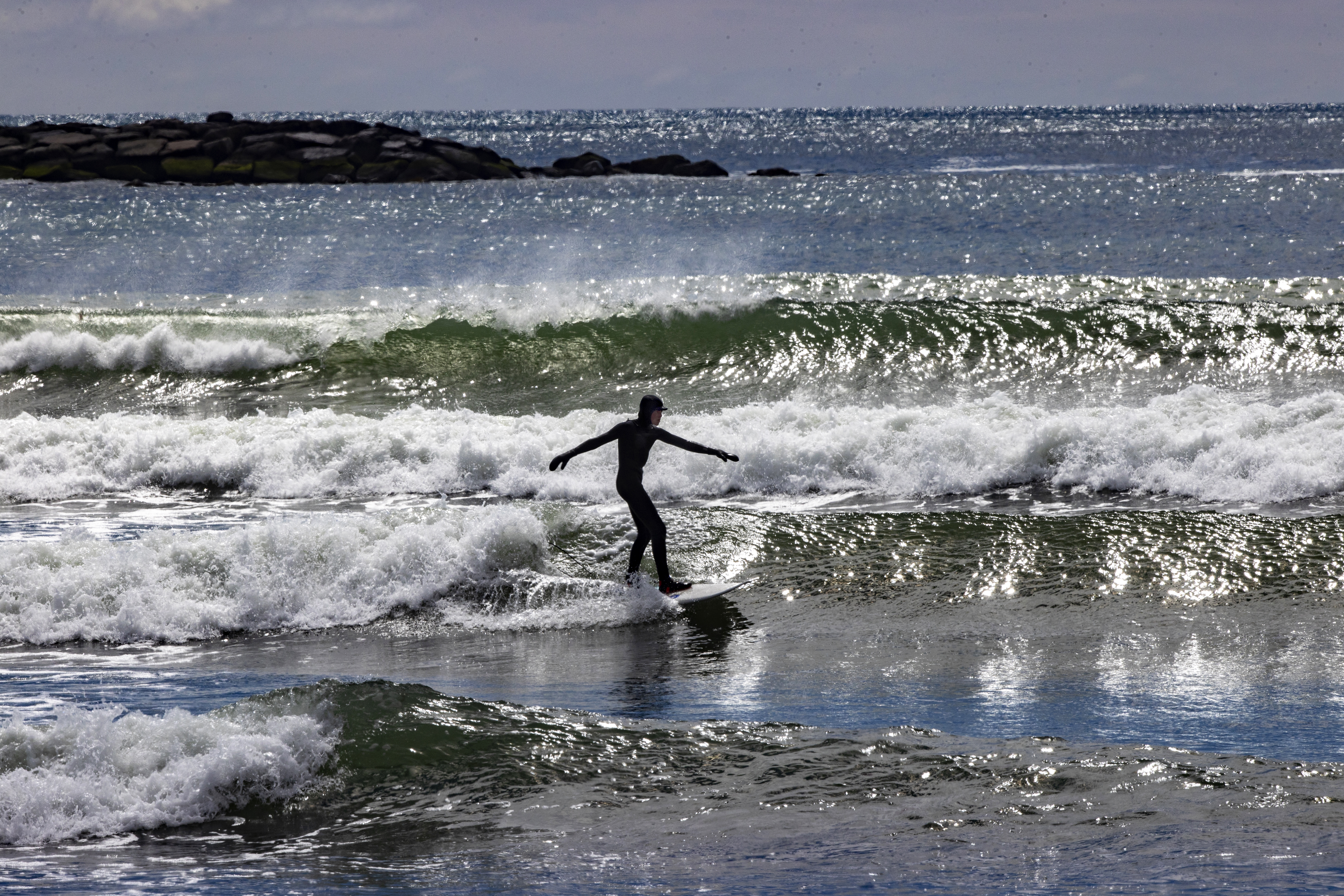 A solitary surfer rides a wave near Point Judith, R.I., a popular spot, but one where specific details are kept quiet in the possessive tradition of the sport.