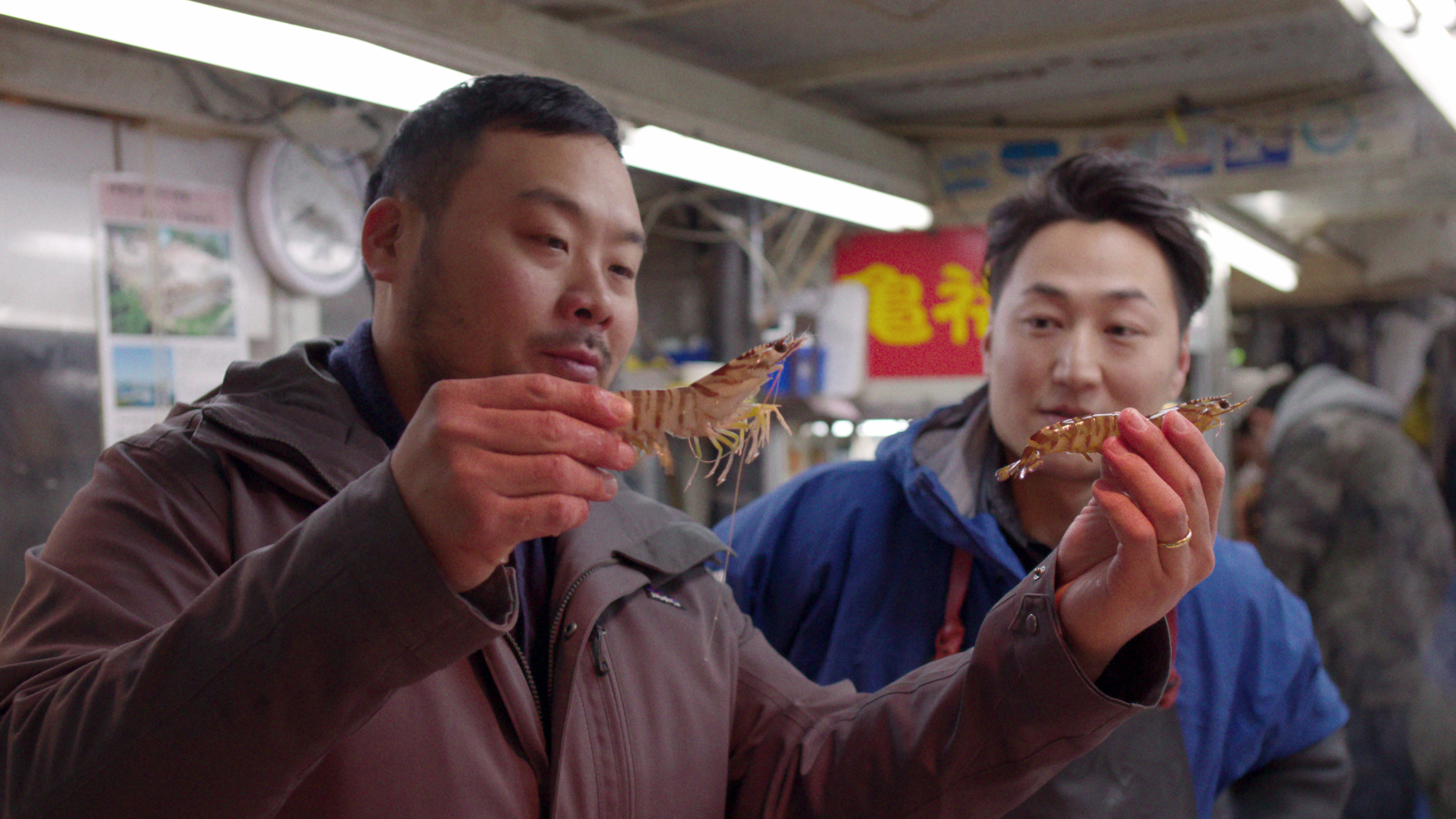 David Chang (left, with vendor Koji Namiki) compares wild and farmed shrimp in Tokyo.