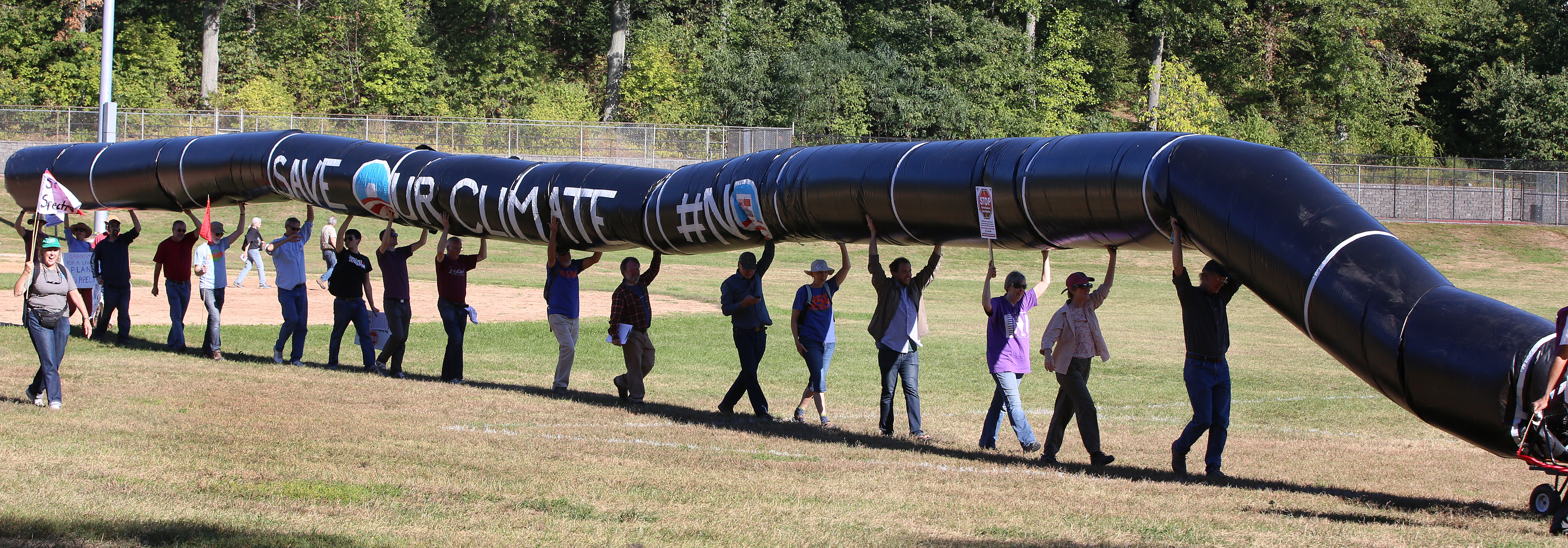 Protesters carried an inflatable pipeline from Billings Field to the proposed site of the metering and regulating station.