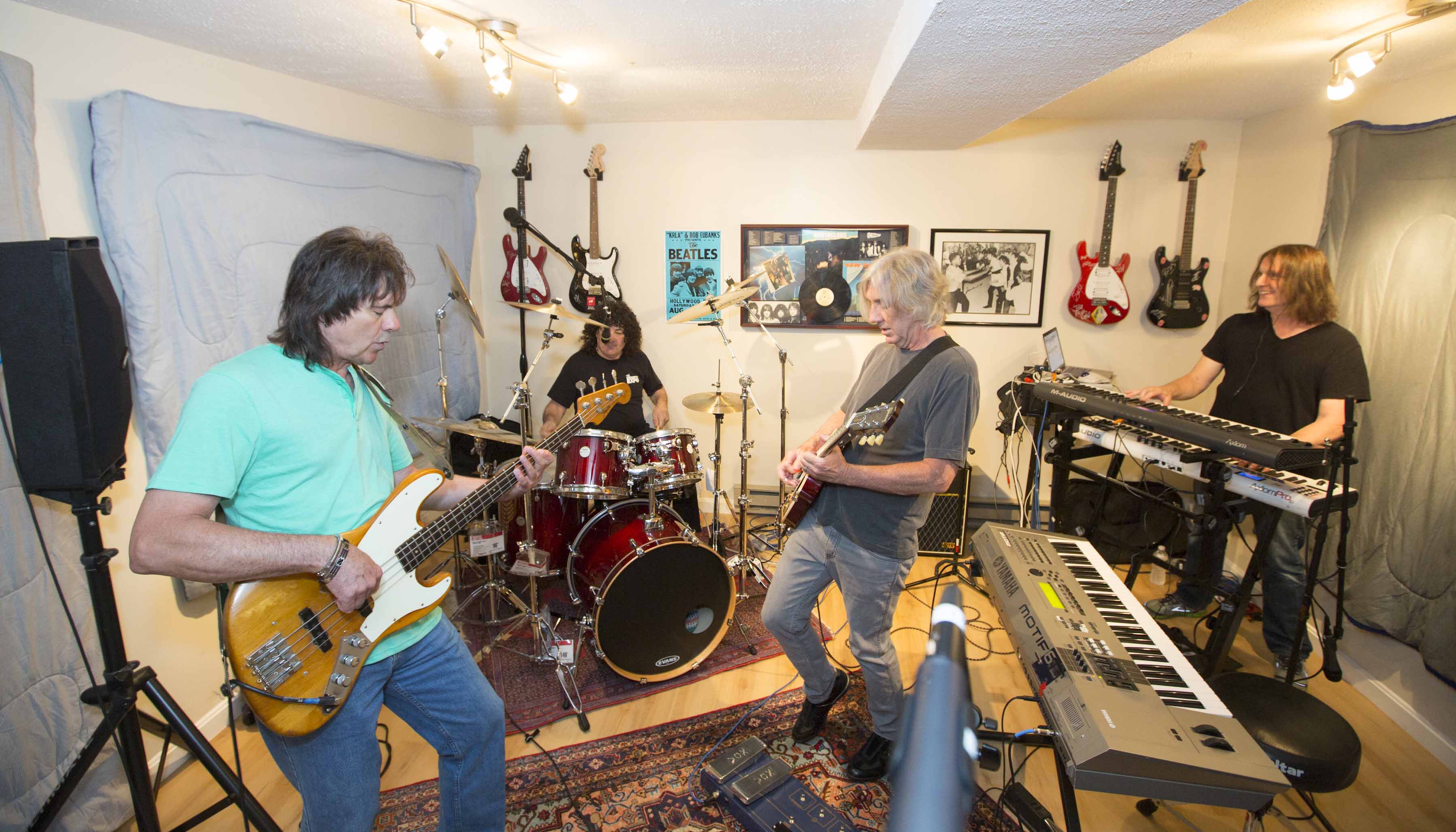 The band New England: bass player Gary Shea, drummer Hirsh Gardner, guitarist John Fannon, and keyboard player Jimmy Waldo.
