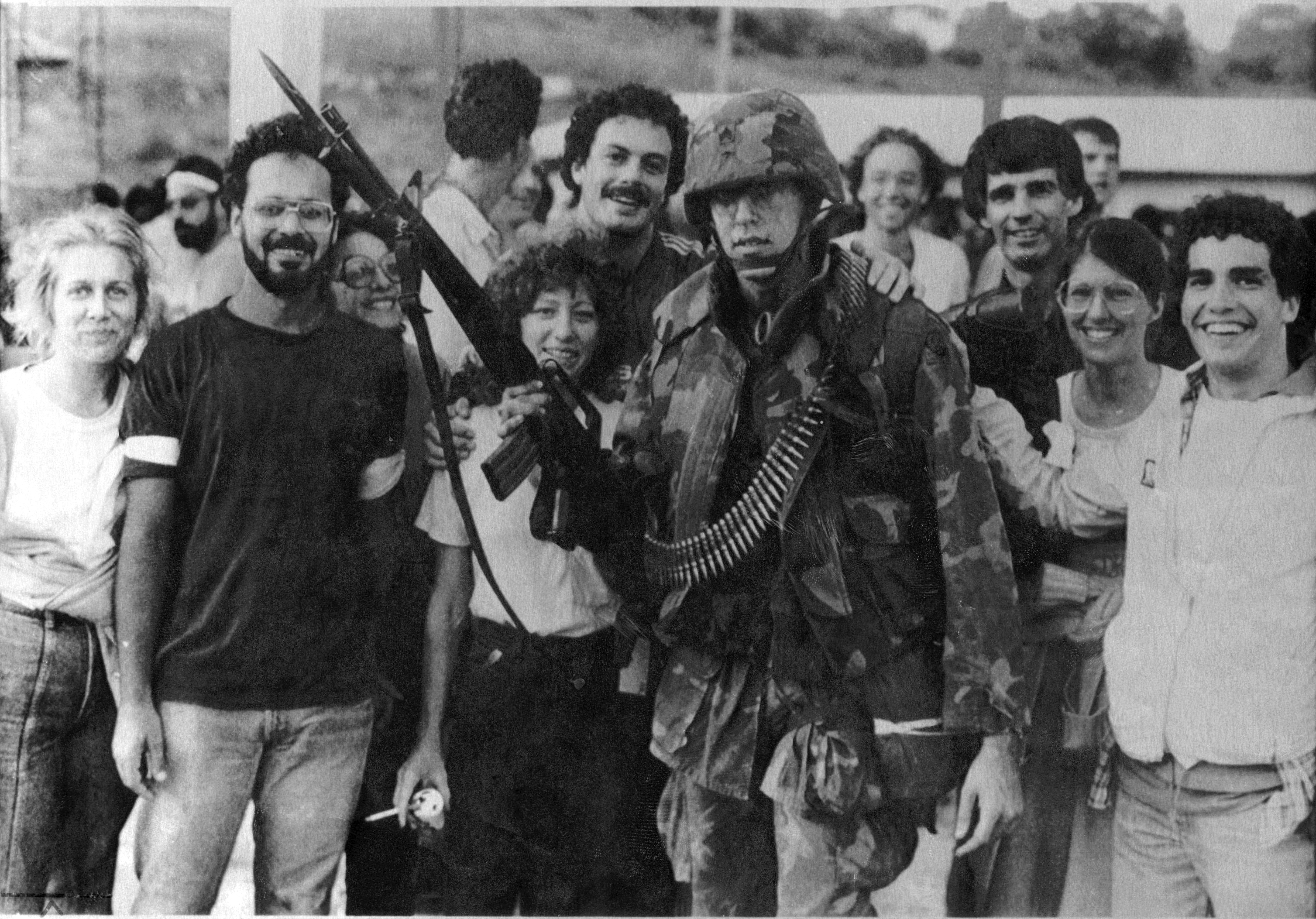 A solider posed with students from the school after the invasion.