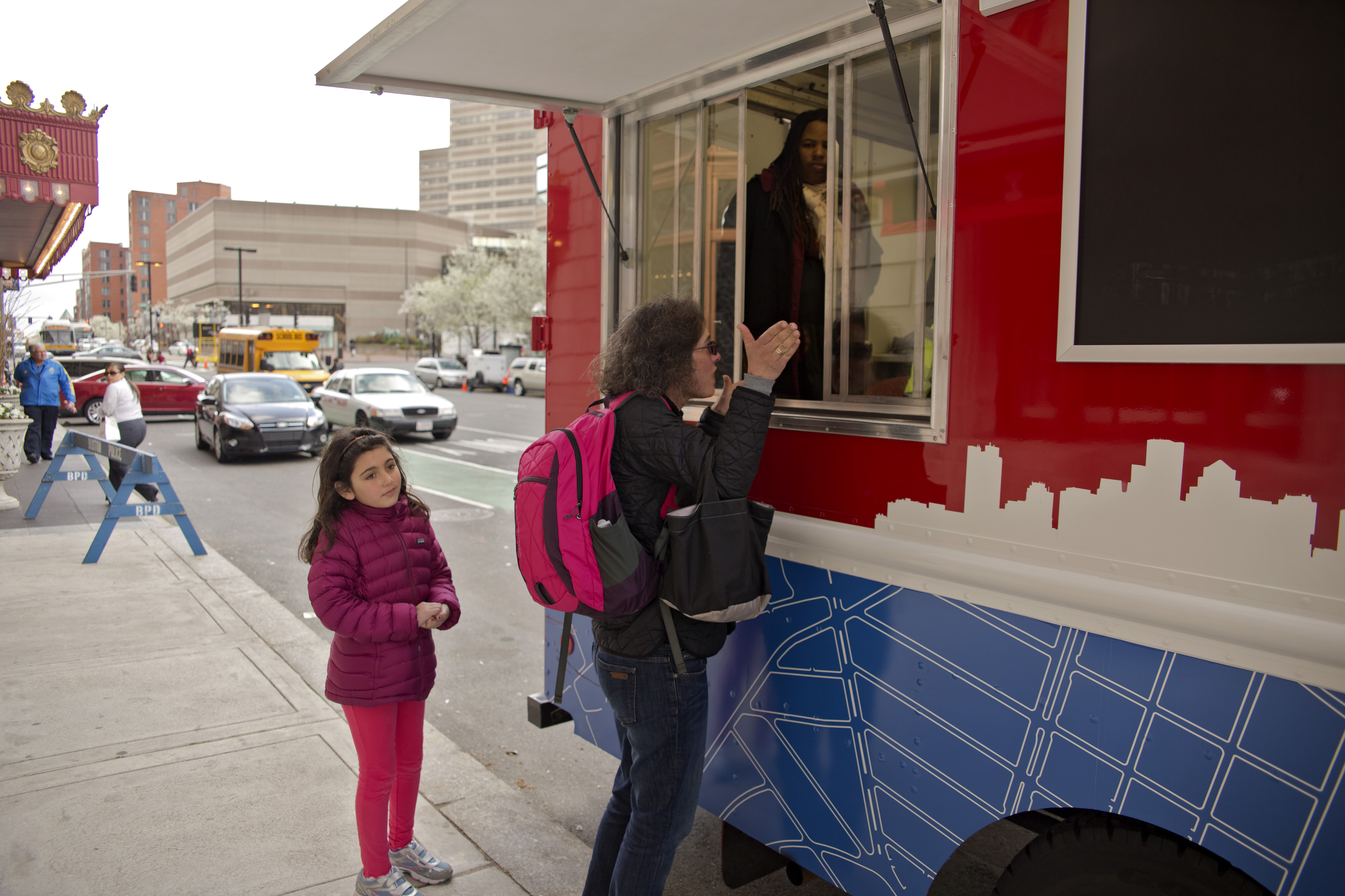 Boston, MA 4/22/2013 Rachel Hamlin (cq) and her daughter, Sophia Hamlin (cq),9, area residents visitin the Mobile City Hall on St. James Street and Dartmouth Streets to find out when they will open the street to residents on Monday April 22 2013. They have to walk more than six blocks to go shopping on Newbury Streeta and it makes her feel uncomfortable to walk past the shrine with her young daughter so often. (Mattthew J. Lee/Globe staff) Topic: 23monent Reporter: