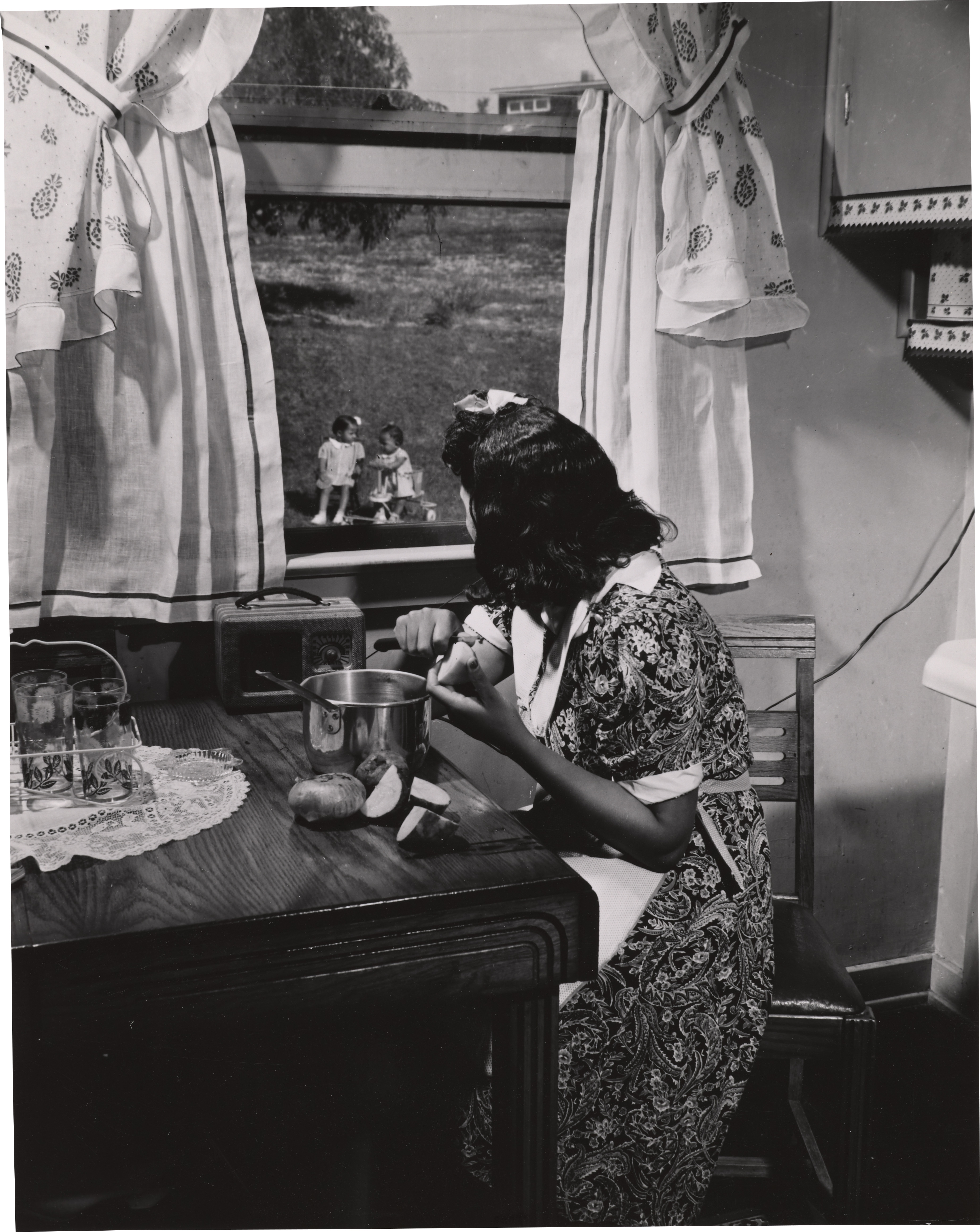 Gordon Parks, "Anacostia, D.C. Frederick Douglass housing project. Mother watching her children as she prepares the evening meal," 1942