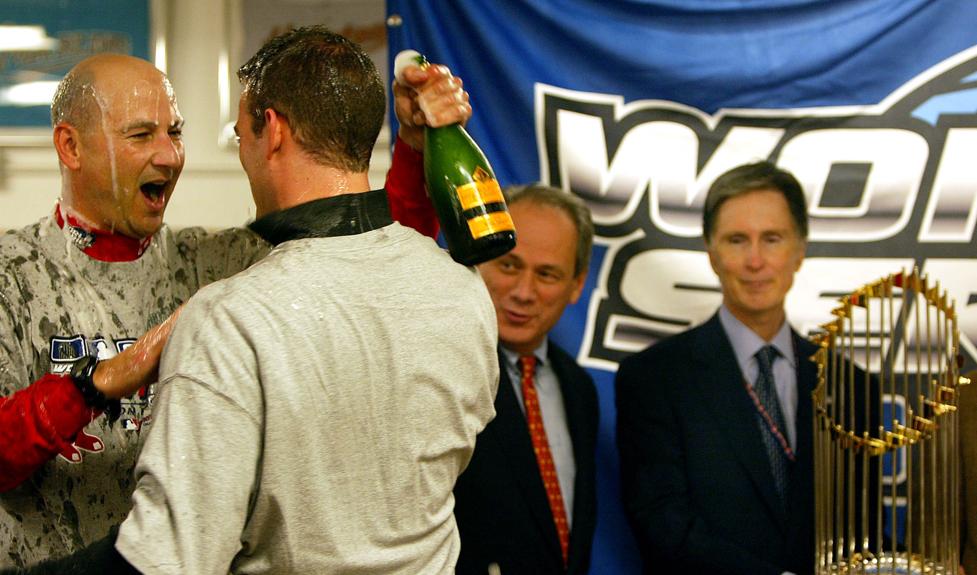 From left: Terry Francona, Theo Epstein, Larry Lucchino, and John Henry in the locker room after the team’s 2004 World Series victory.