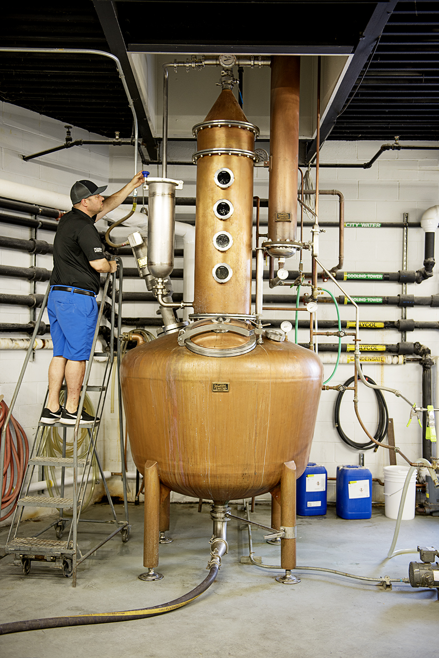 Sons of Liberty founder Mike Reppucci checking the progress of a batch of gin.