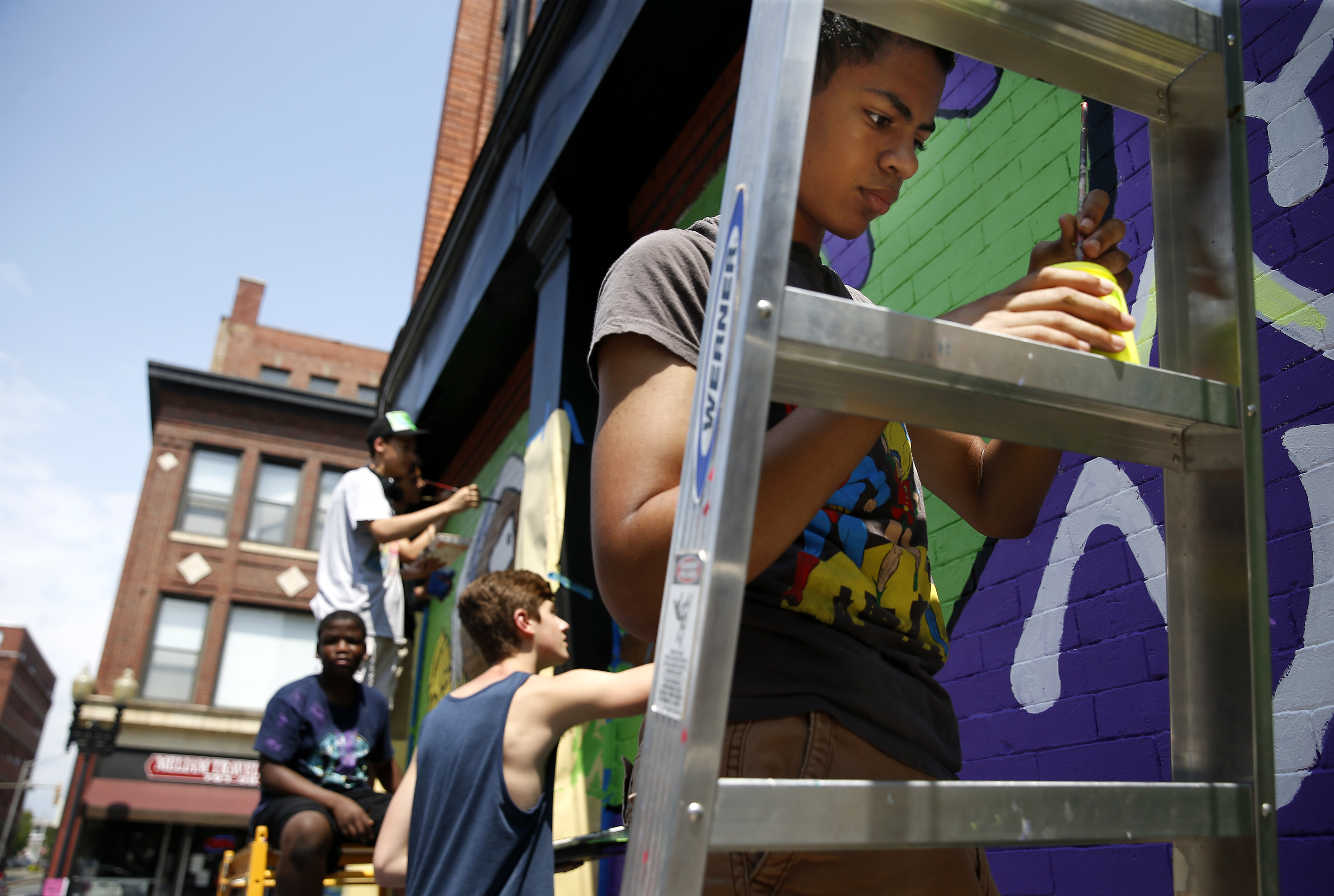 Elijah Fernandes, right, worked with others on public art projects in Lynn.