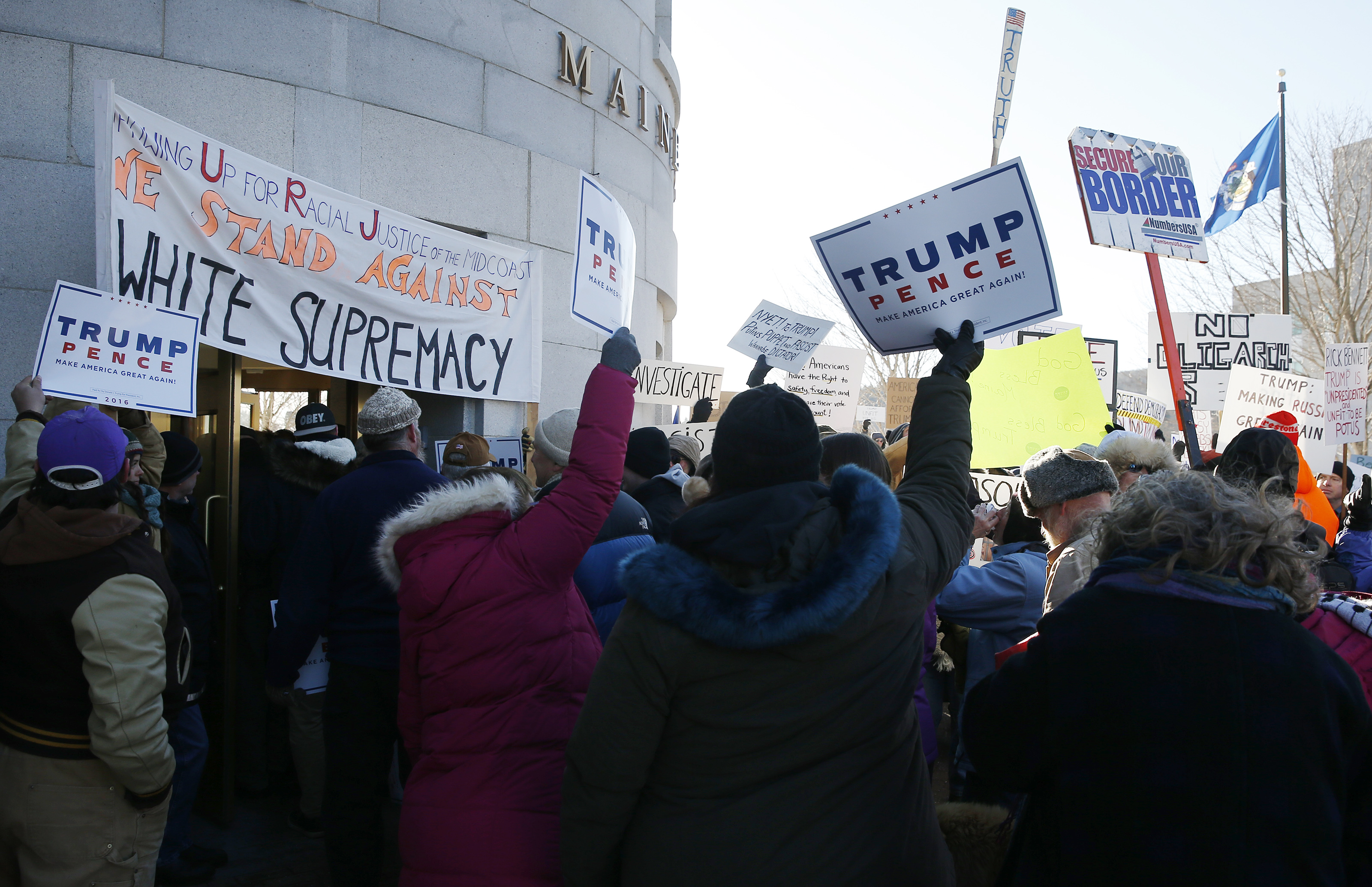 Republicans marching to escort elector Rick Bennett wee met with opposition outside of the State House in Augusta, Maine.