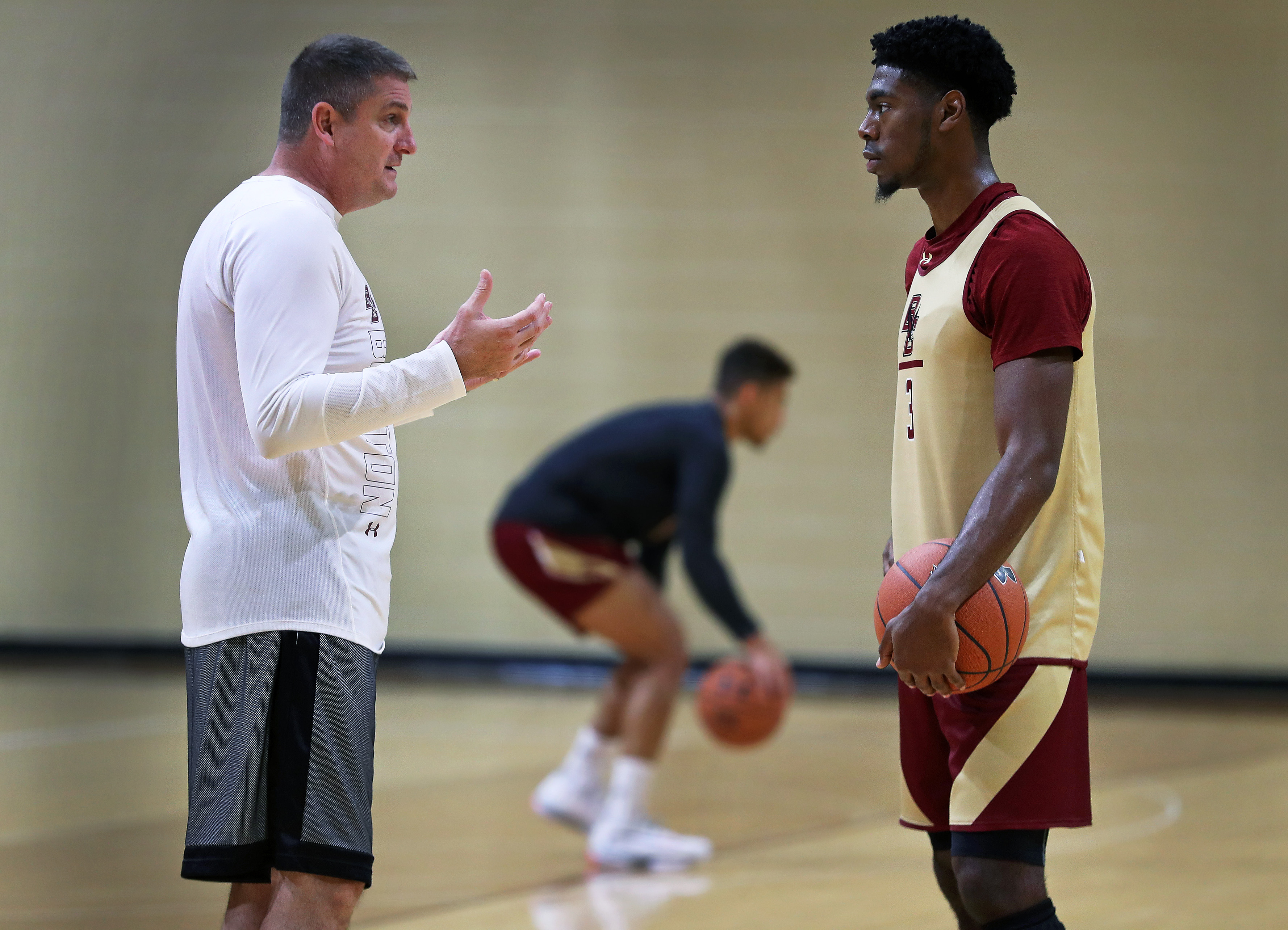 BC basketball coach Jim Christian (left) talks with Jared Hamilton during practice Tuesday.