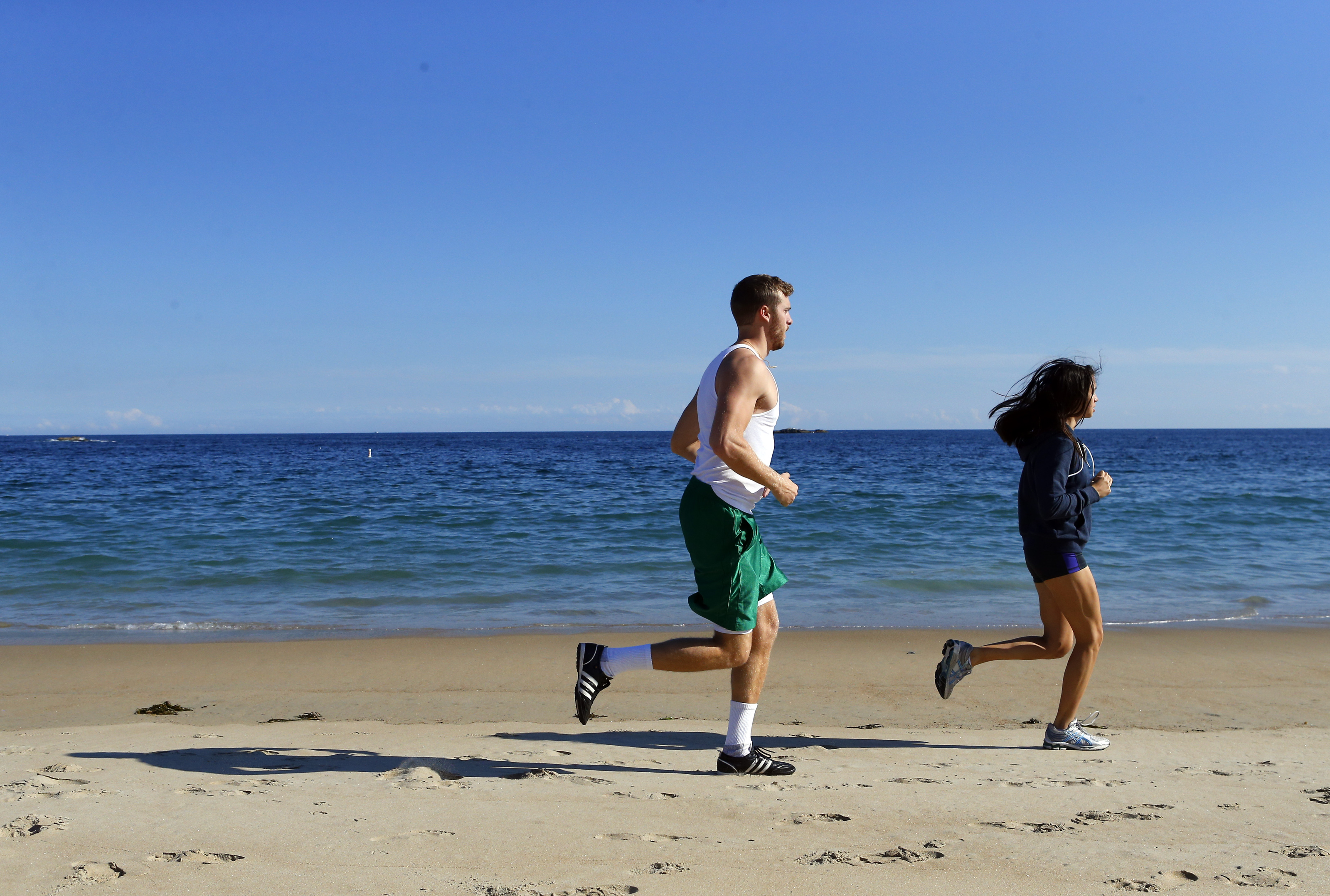 People run along Singing Beach in Manchester-by-the-sea.