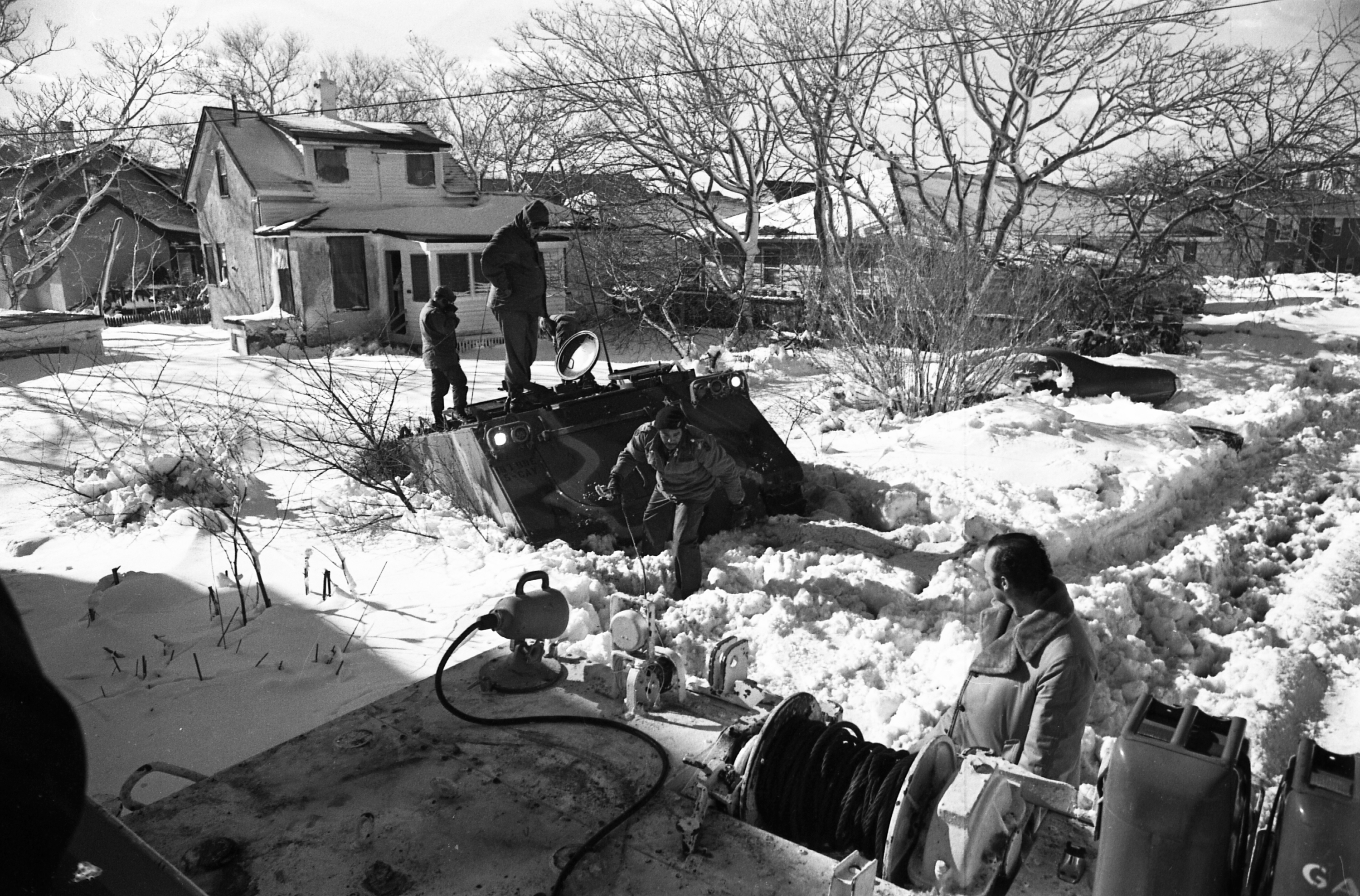 Army personnel from Fort Devens were stuck in the slush after trying to rescue a couple in their home on a flooded and frozen street in Revere.