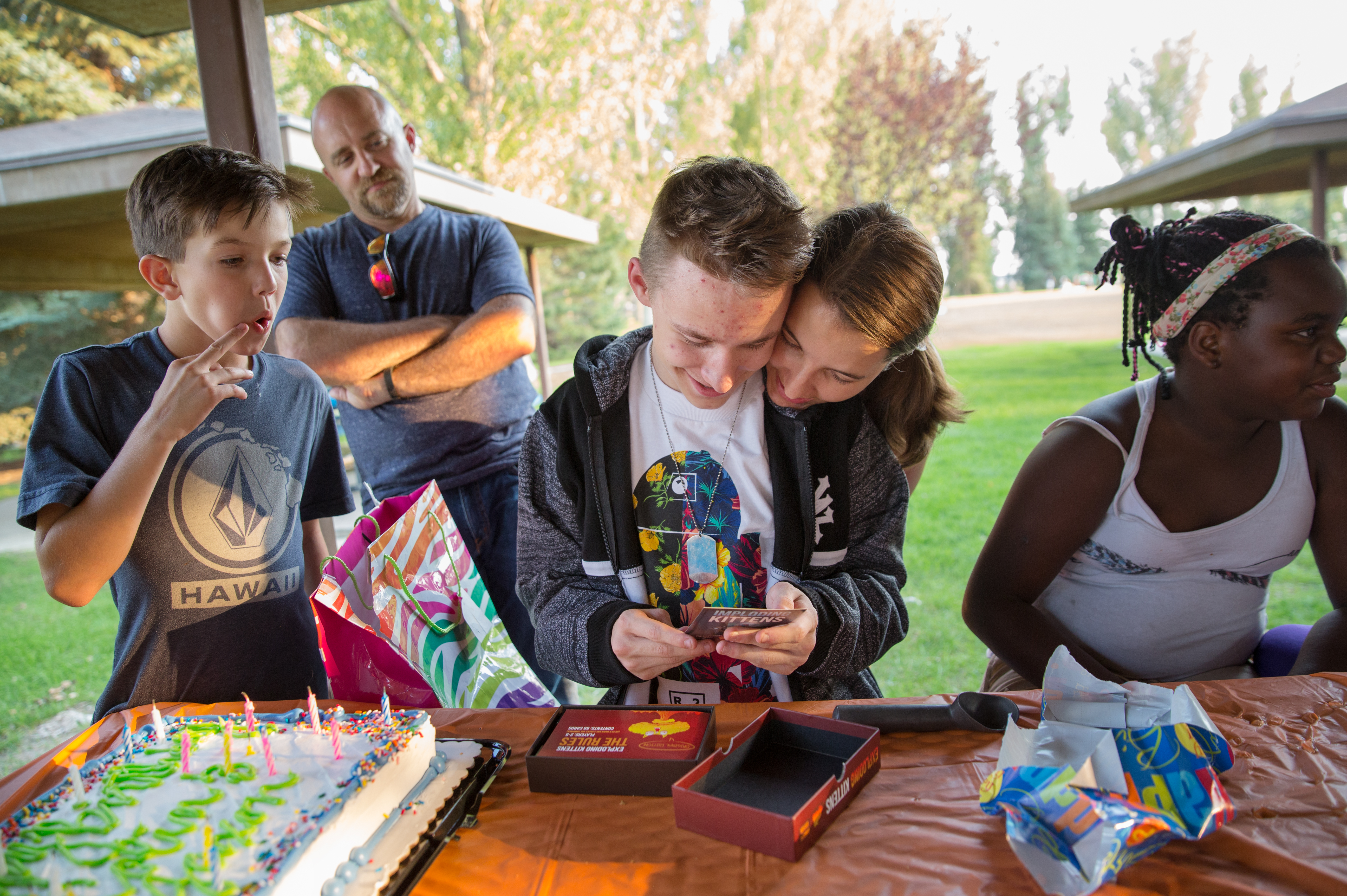 Colin English (center) looks at a birthday present with his sister Nonni at his birthday party last September in Utah. Colin has spinal muscular atrophy.