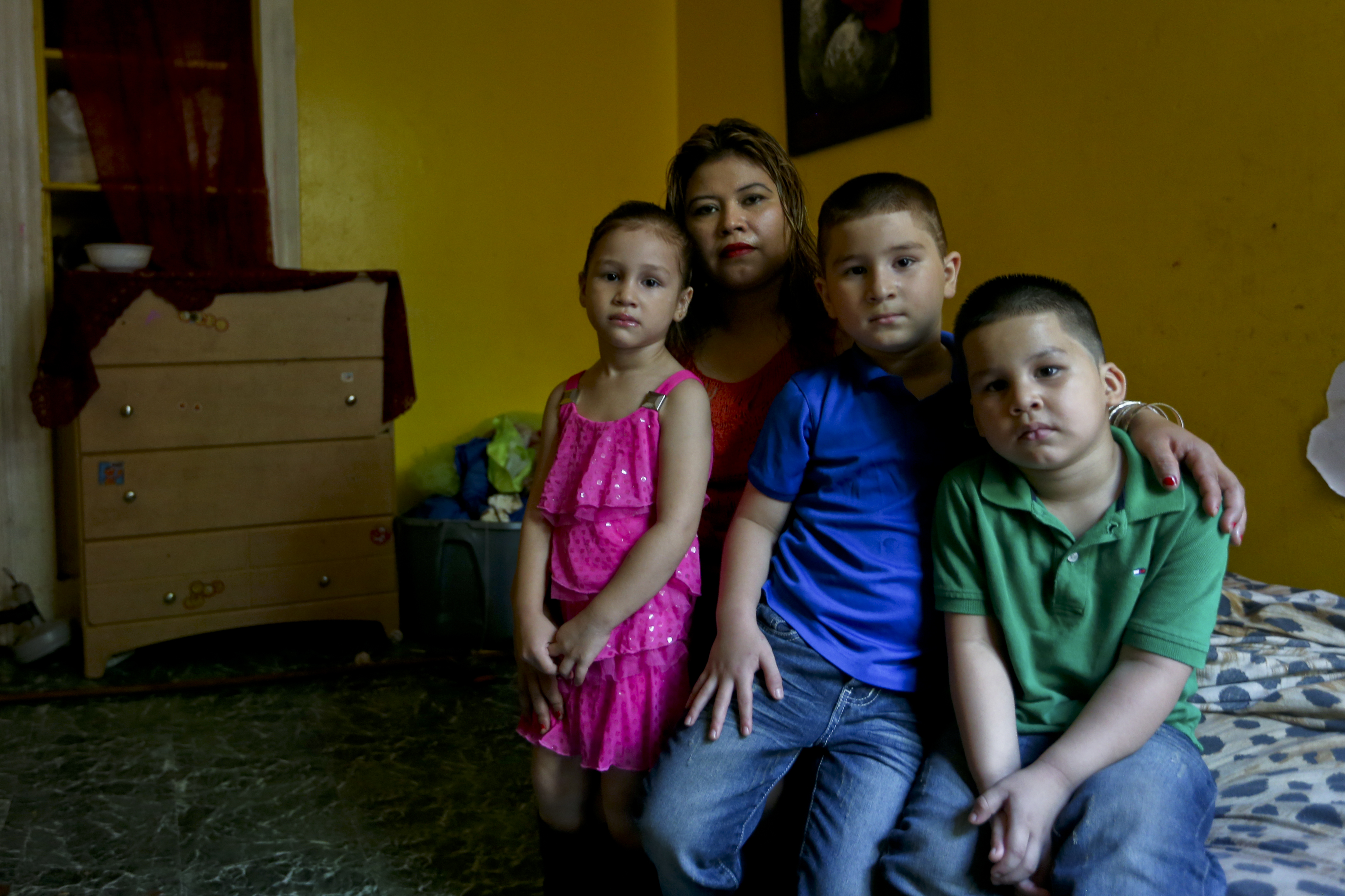 Glendy Garcia posed in her home with her children Shelsea, Jose, and William. Shelsea and Jose had been diagnosed with lead poisoning.