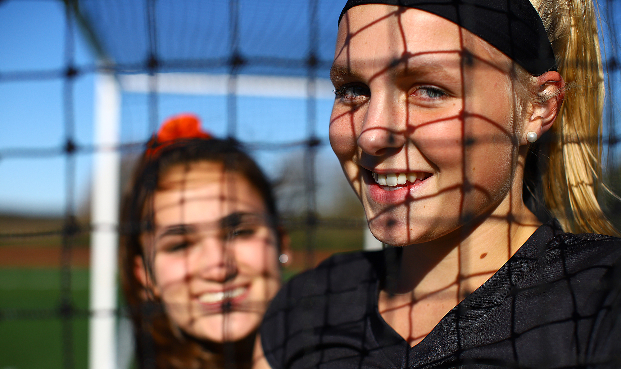 Rixt van der Kooi, an exchange student from the Netherlands, has developed a strong bond with her host sister, senior captain Maddie Wilson (background).