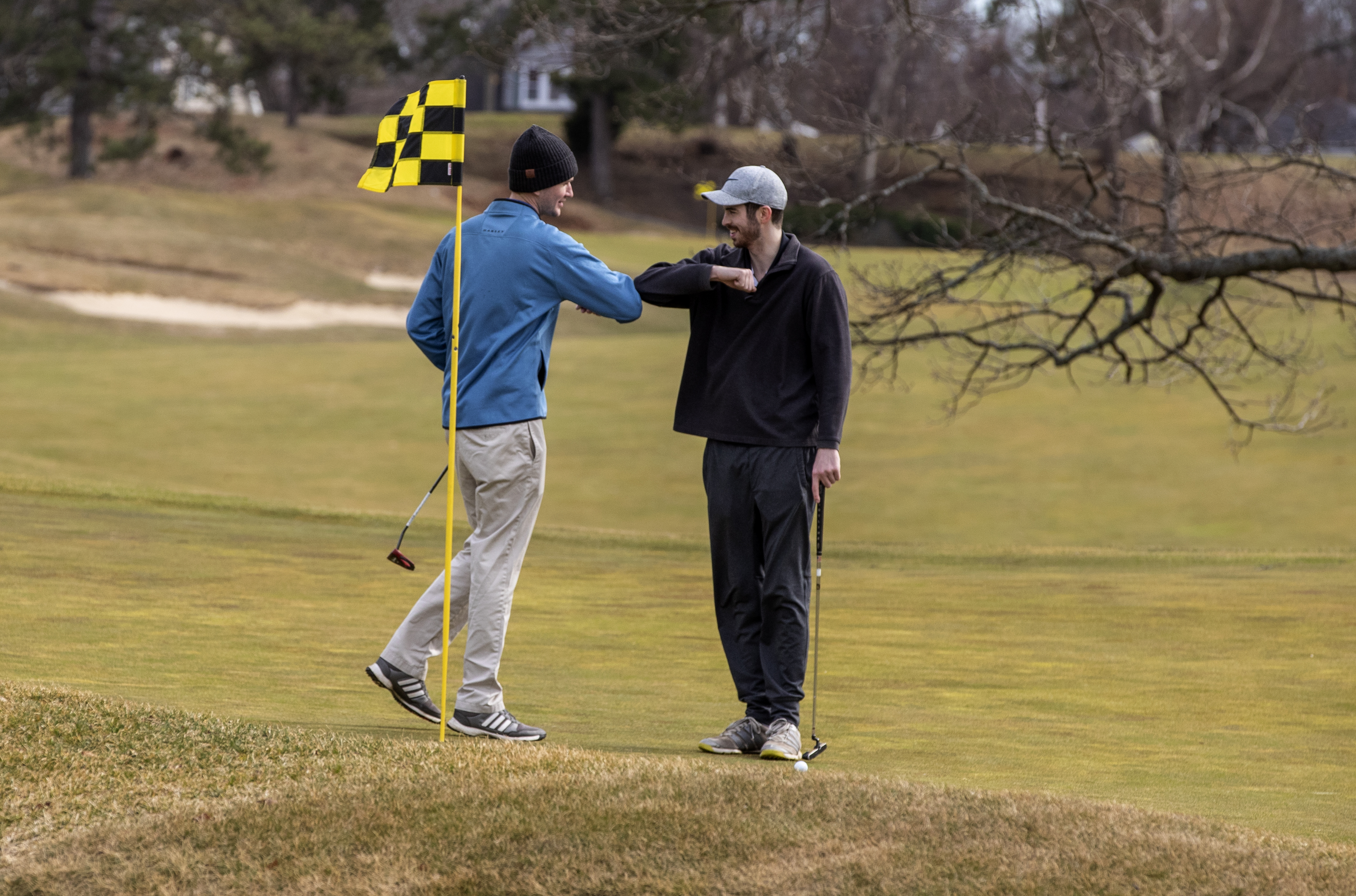 Tee times sold out at Presidents Golf Course on Saturday, where two golfers avoided more traditional high-fives in favor of elbow knocks.