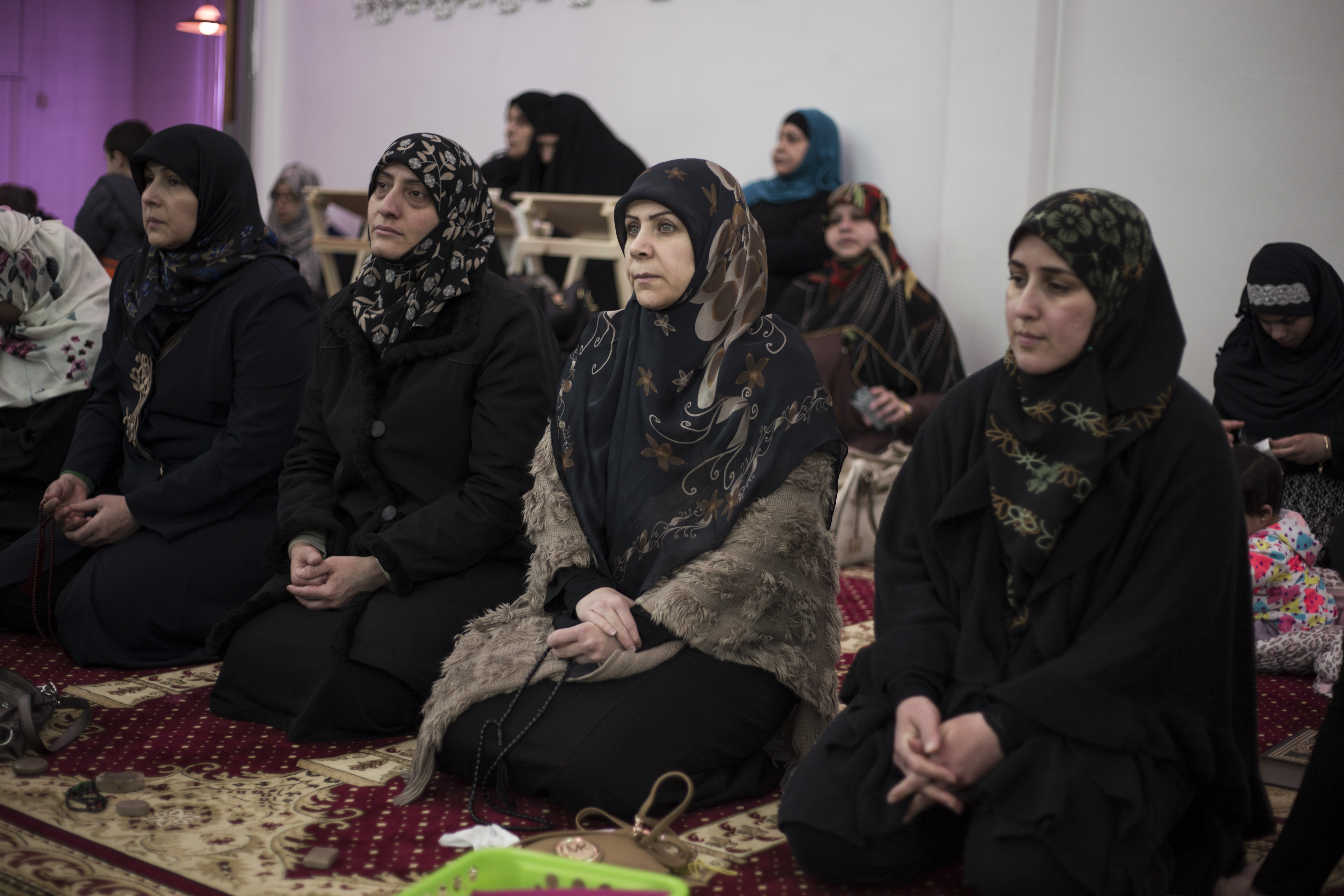 Women listened as Imam Hassan Qazwini spoke during a recent service.