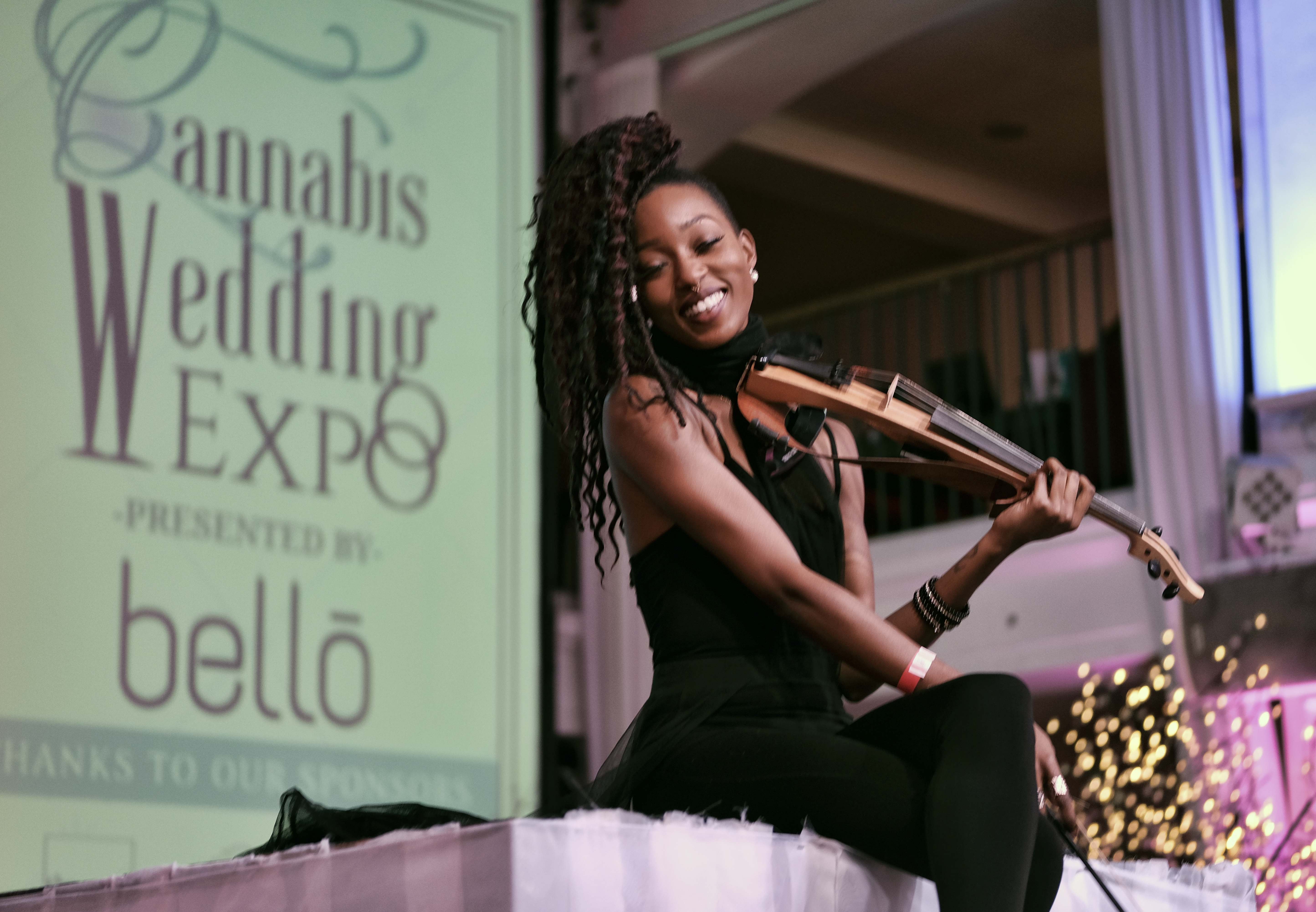 Violinist Crissy J plays on stage.