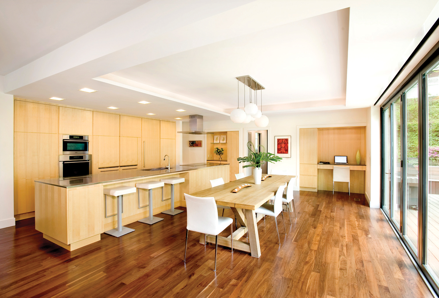 Inside, an outdoor picnic table adds a rustic element to the kitchen and dining area.