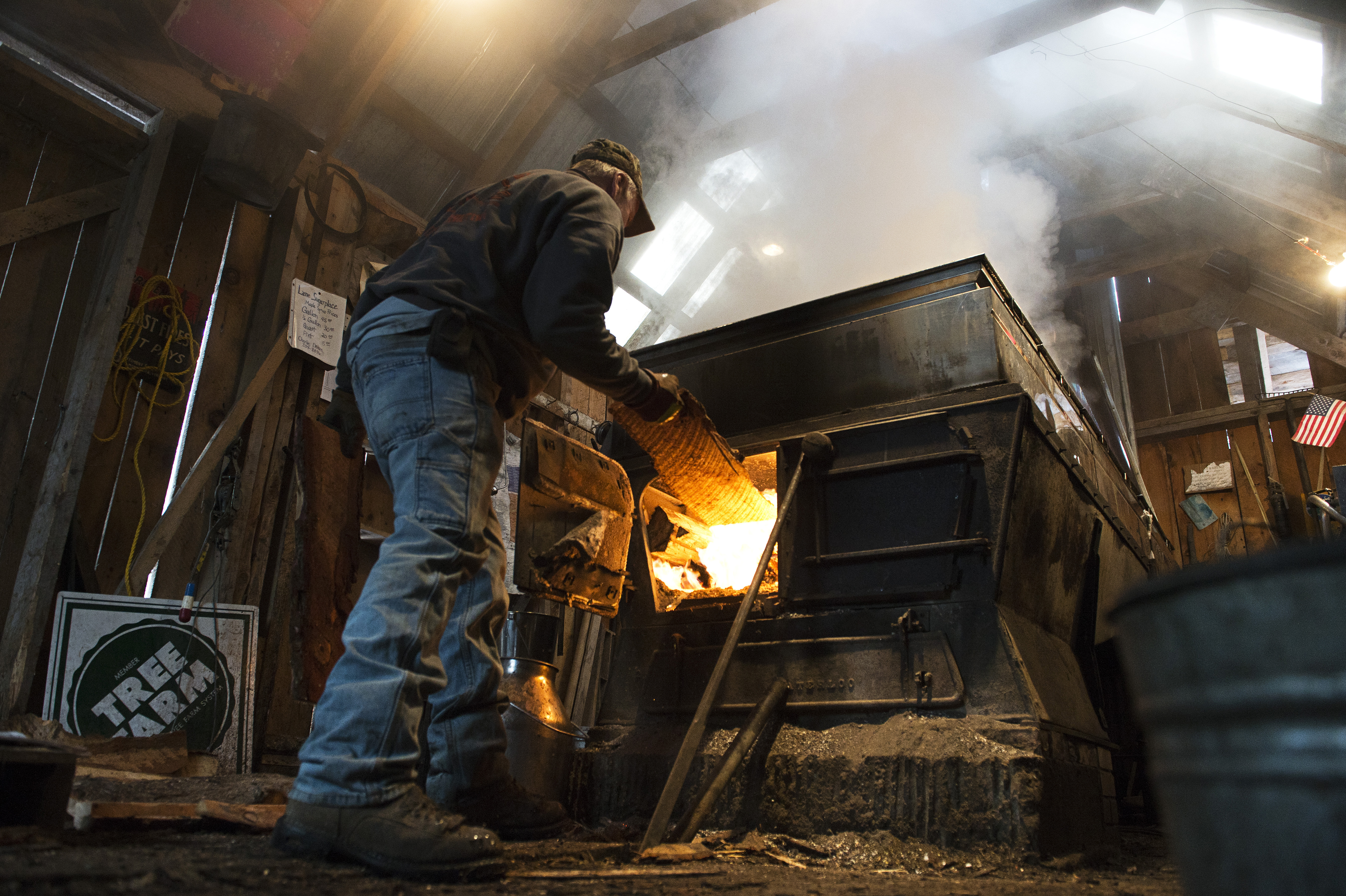 Mike St. Onge fed wood into an evaporator at the Lane Sugarplace in Coventry, Vt.