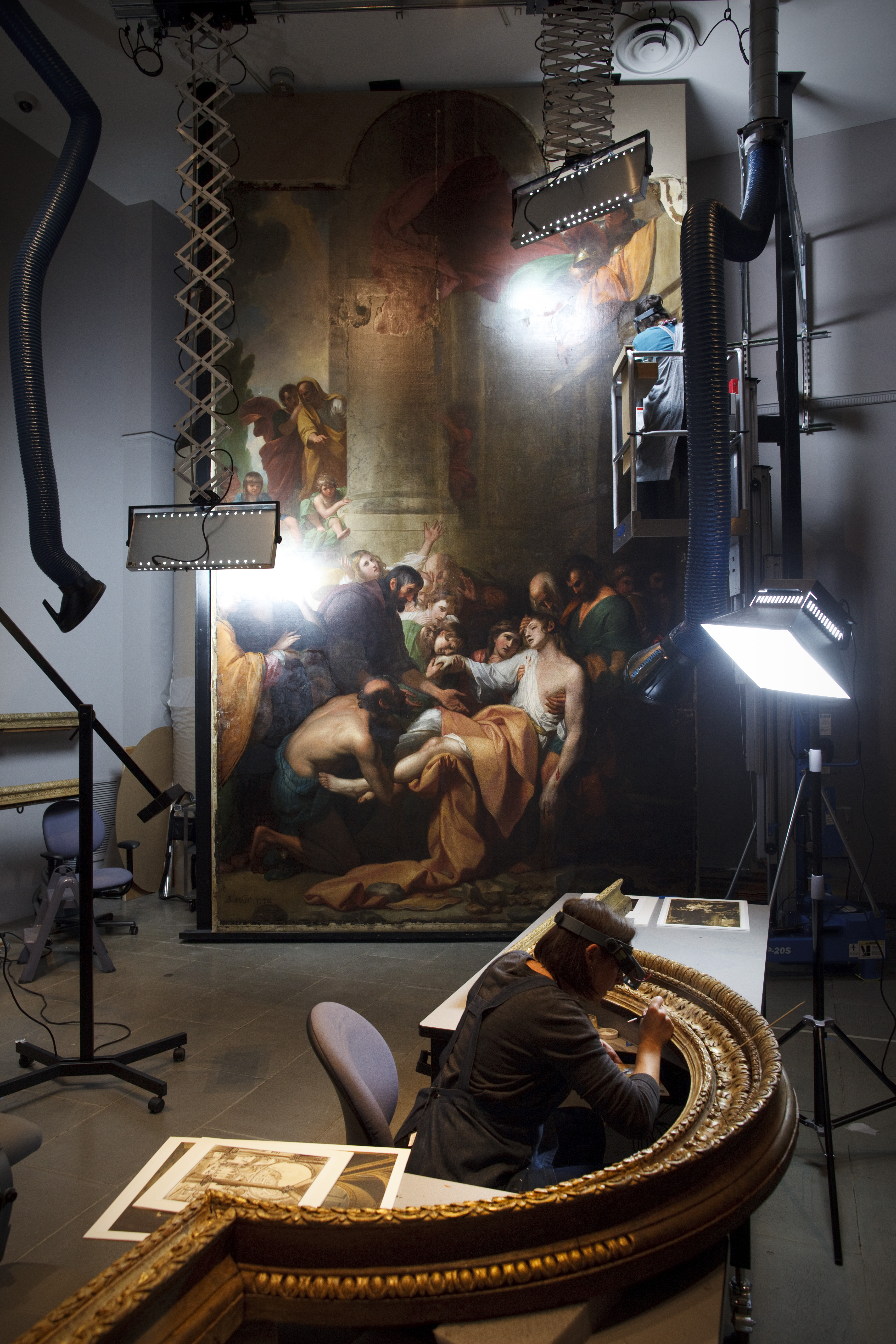 Benjamin West’s painting of St. Stephen and its gilt frame are undergoing restoration at the Museum of Fine Arts.