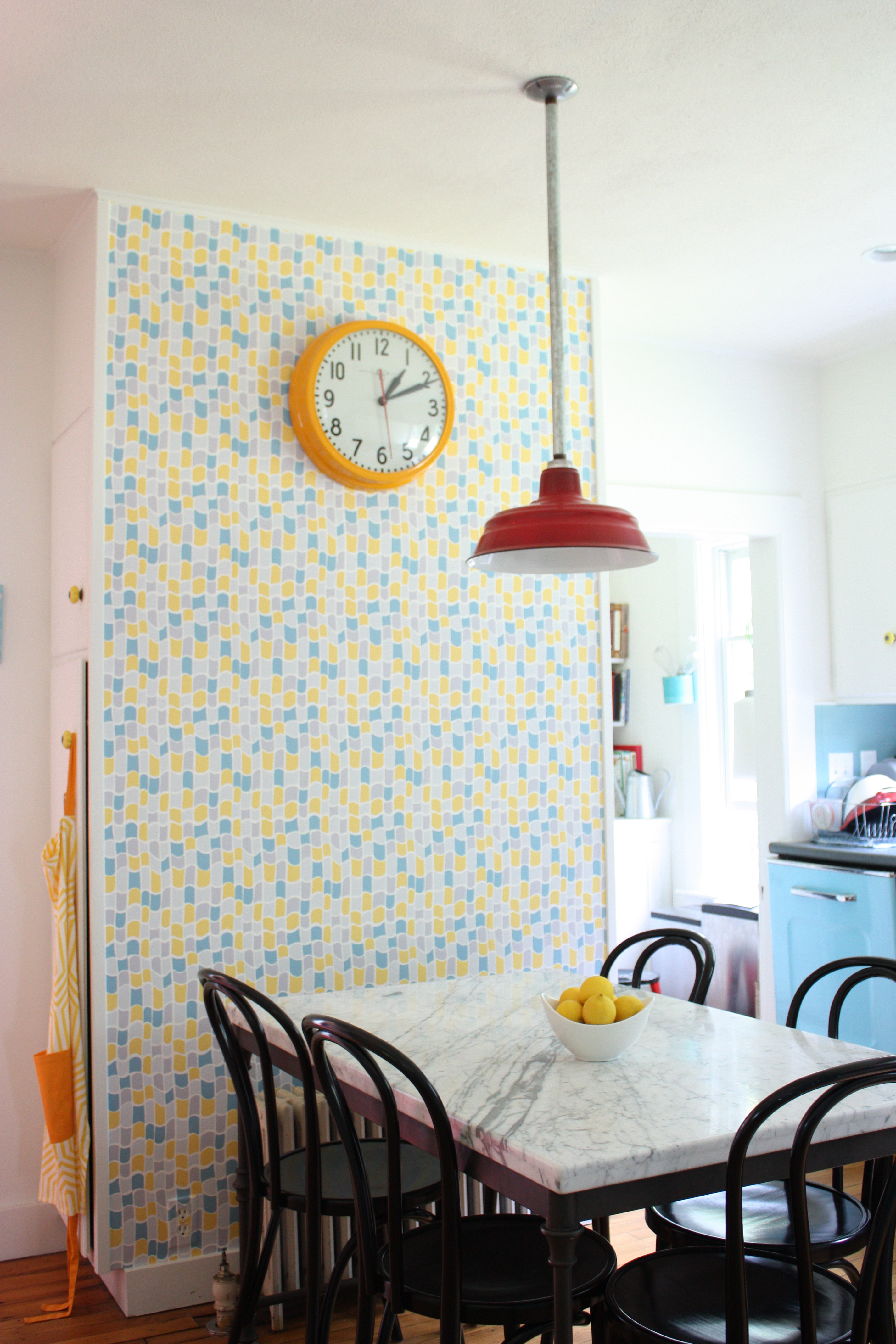 Designer Sally Staub’s kitchen features an accent wall covered in wallpaper.