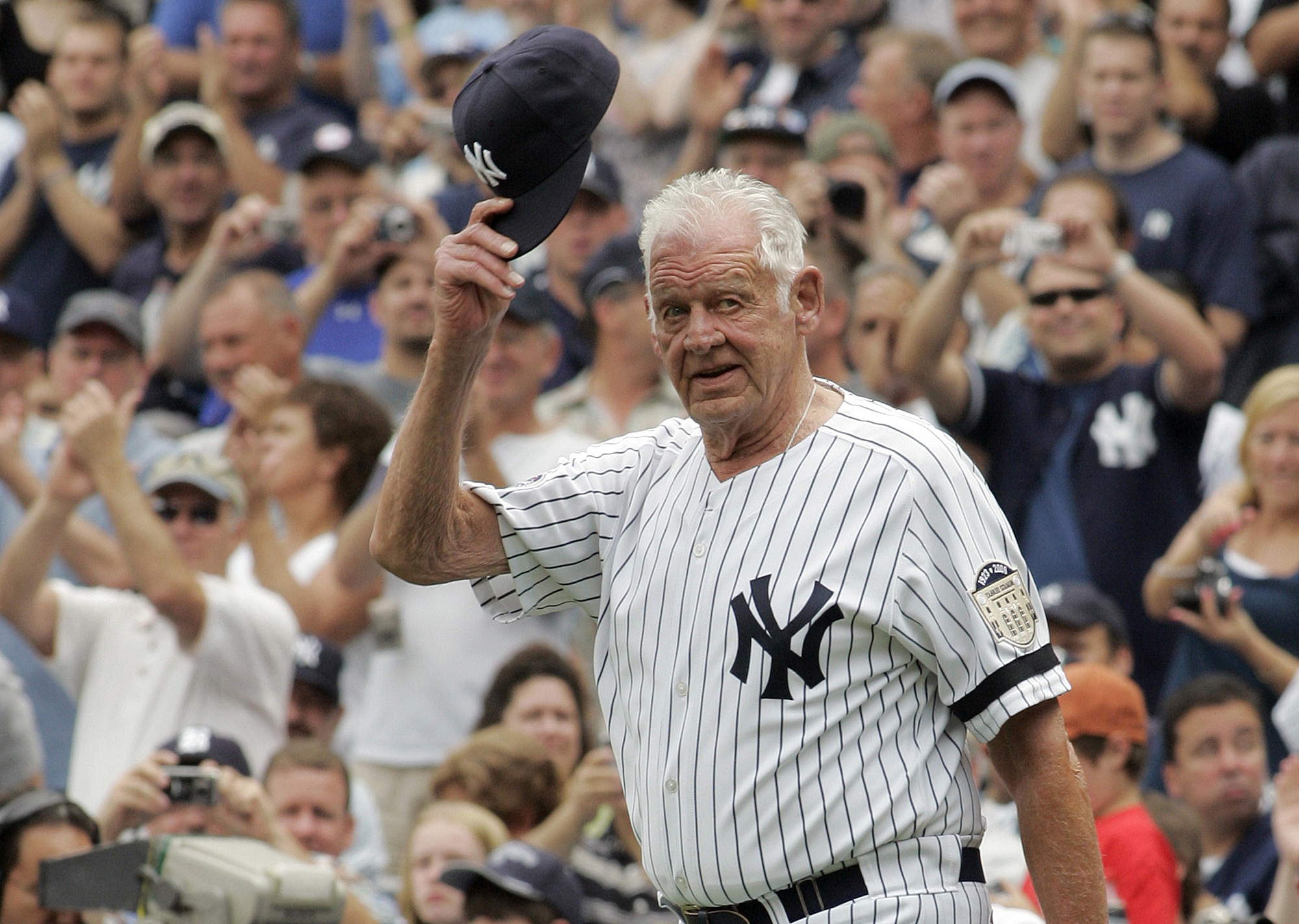 Don Larsen tips his cap to fans during introduction ceremonies before an old-timers game at Yankee Stadium in 2008.