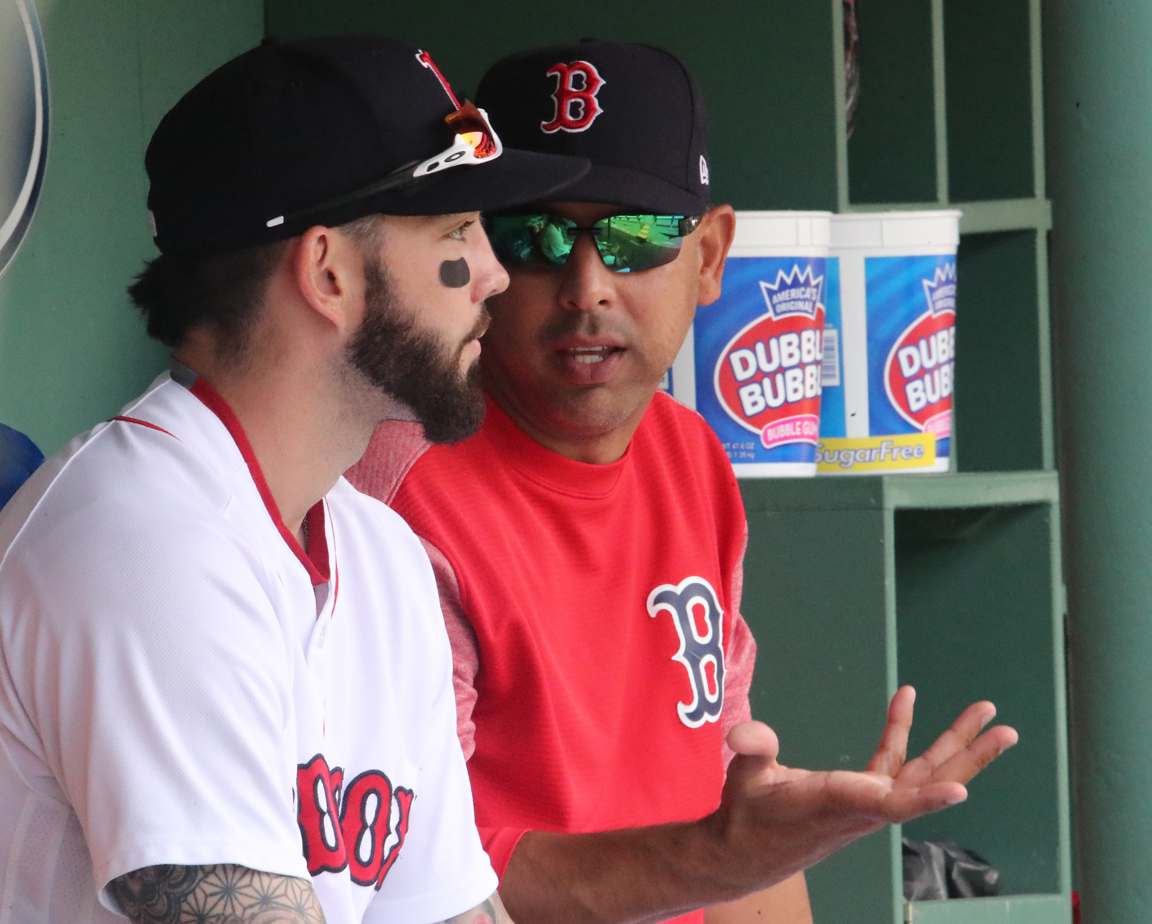Conferring with utilityman Blake Swihart in the dugout.