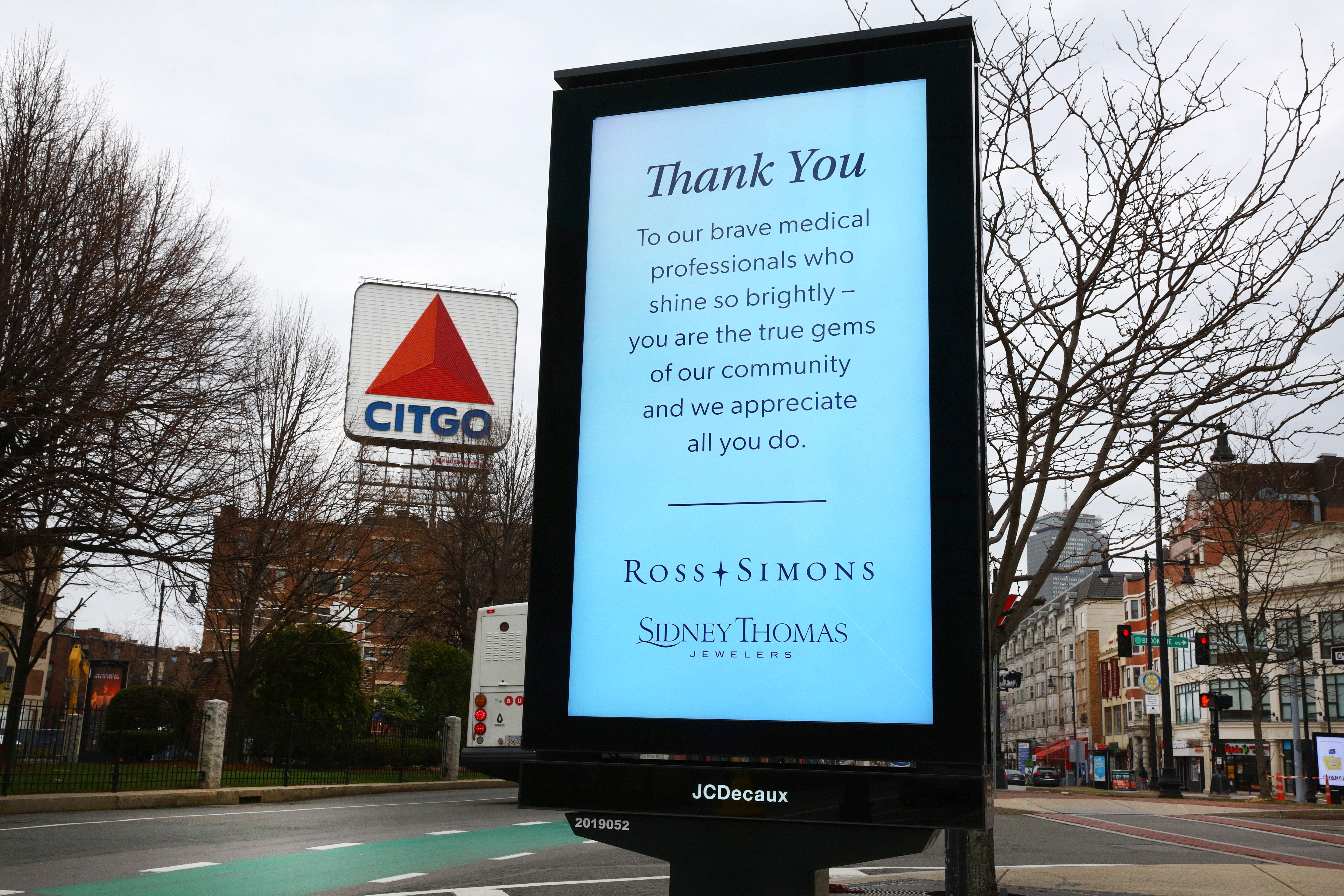 This changing electronic sign in Kenmore Square displayed advertisements with similar themes during the pandemic.