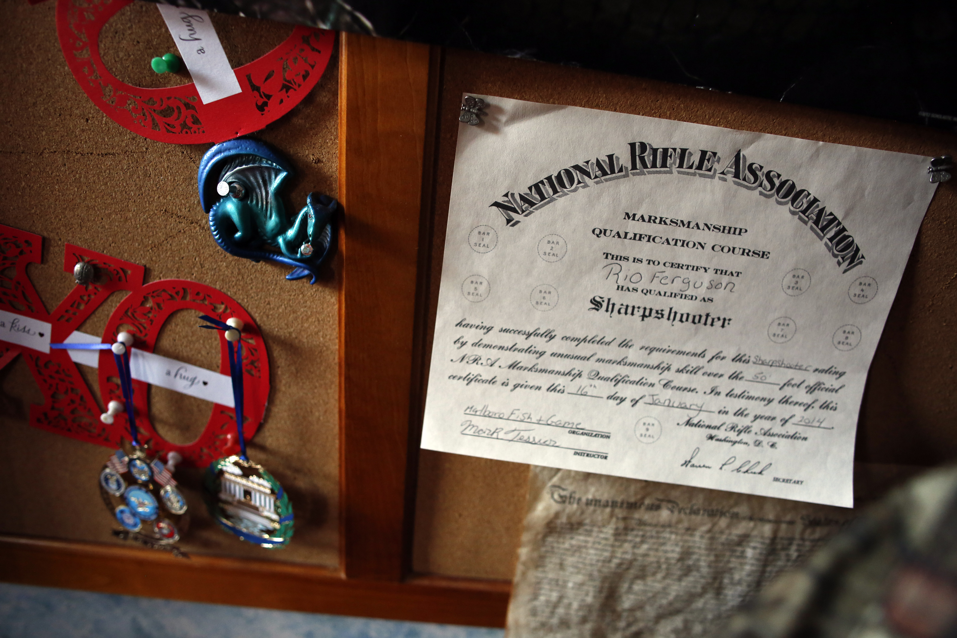 An NRA Marksman Qualification Course certificate hangs on the bulletin board in Rio Ferguson’s bedroom.