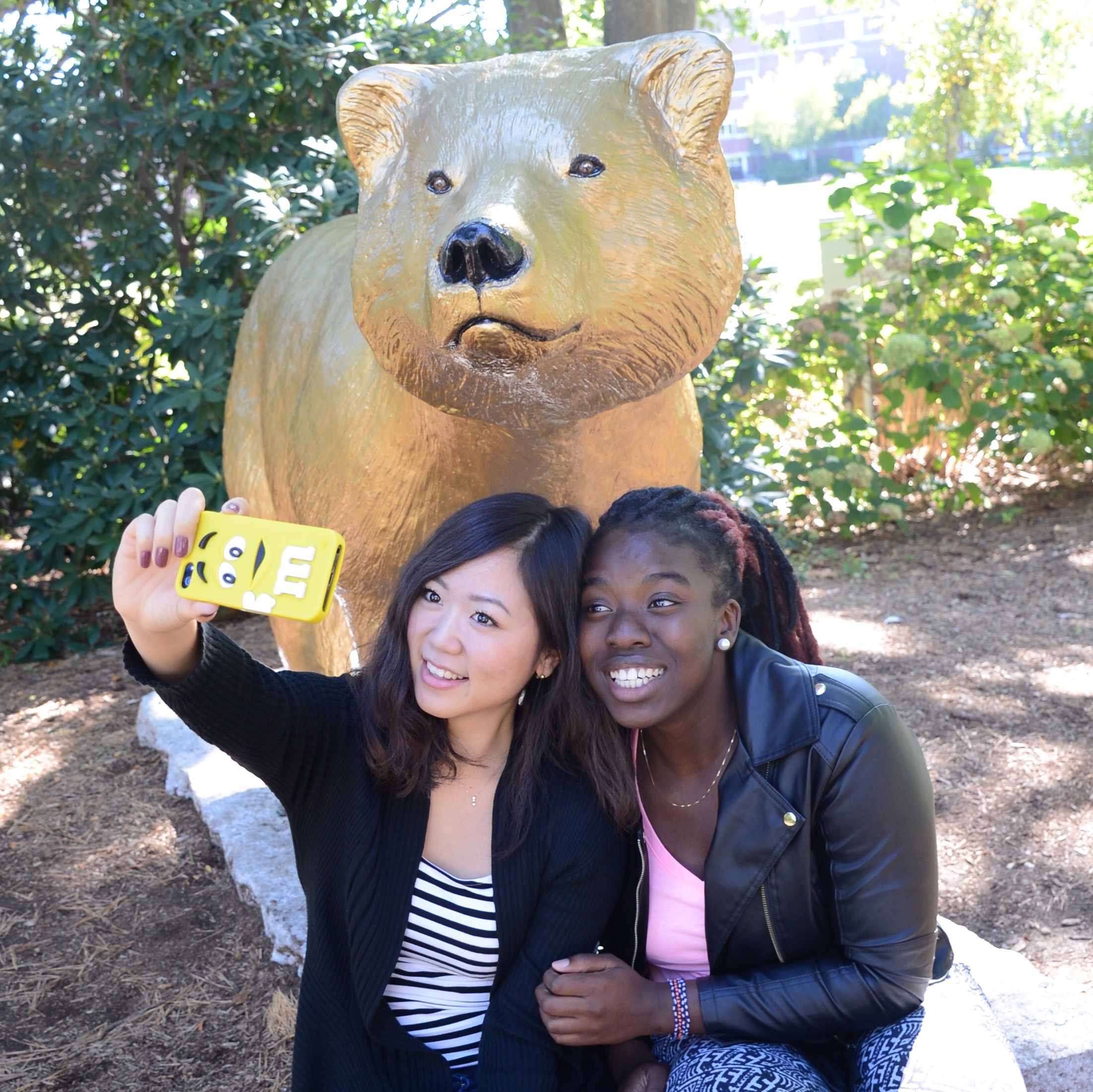 At Western New England University in Springfield, Emi Nanasawa of Tokyo and Shallom Adewale of Lynn snapped a selfie by the Golden Bear mascot.