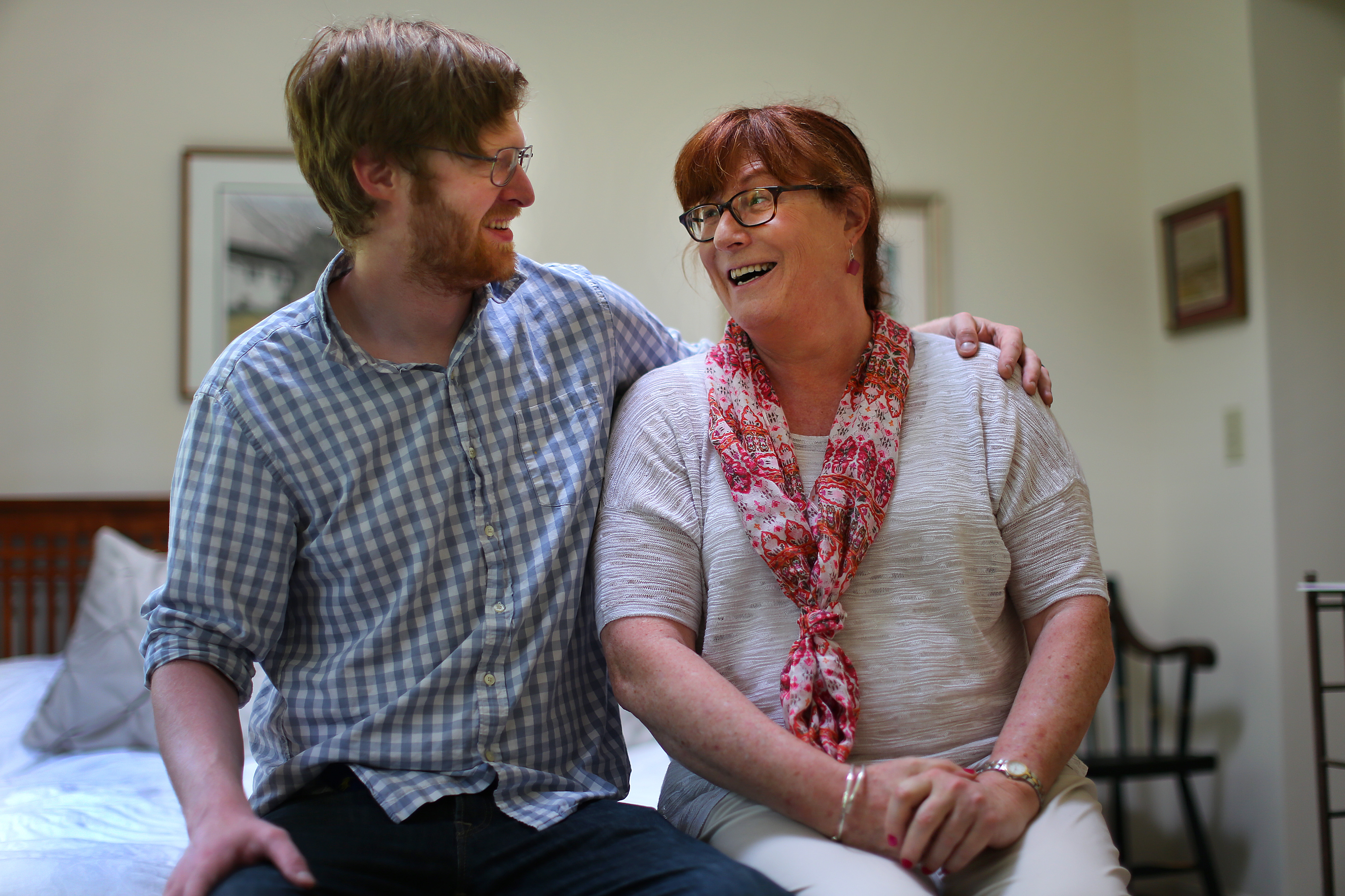 Taylor DeLench (left), with his dad, Lindsey Straus, in her bedroom at her home before she sang in the choir at The First Parish of Brewster Sunday morning service.
