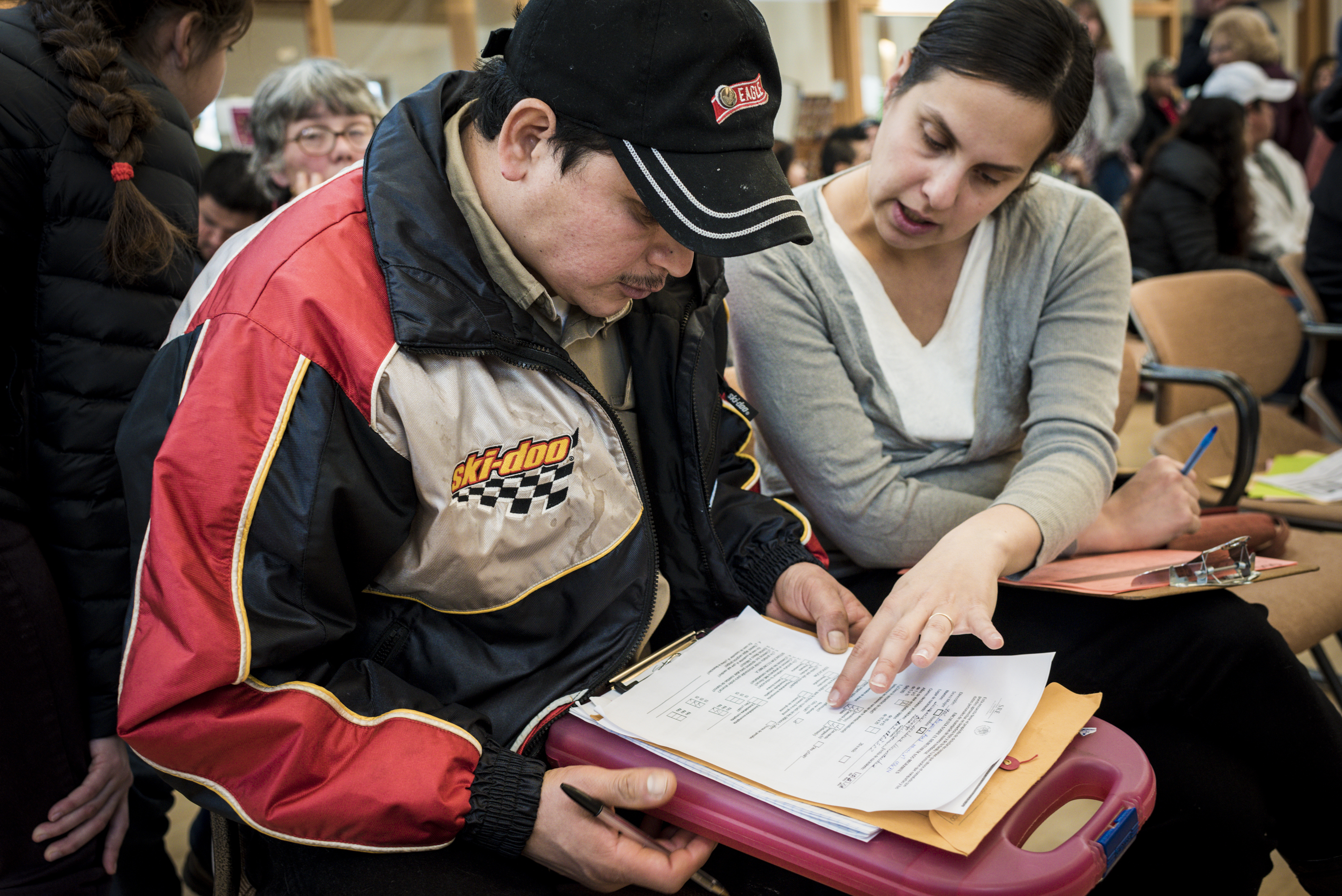 A Mexican national filled out paper work with help from a staff member with the Mexican consulate, in Middleburgy, Vt.