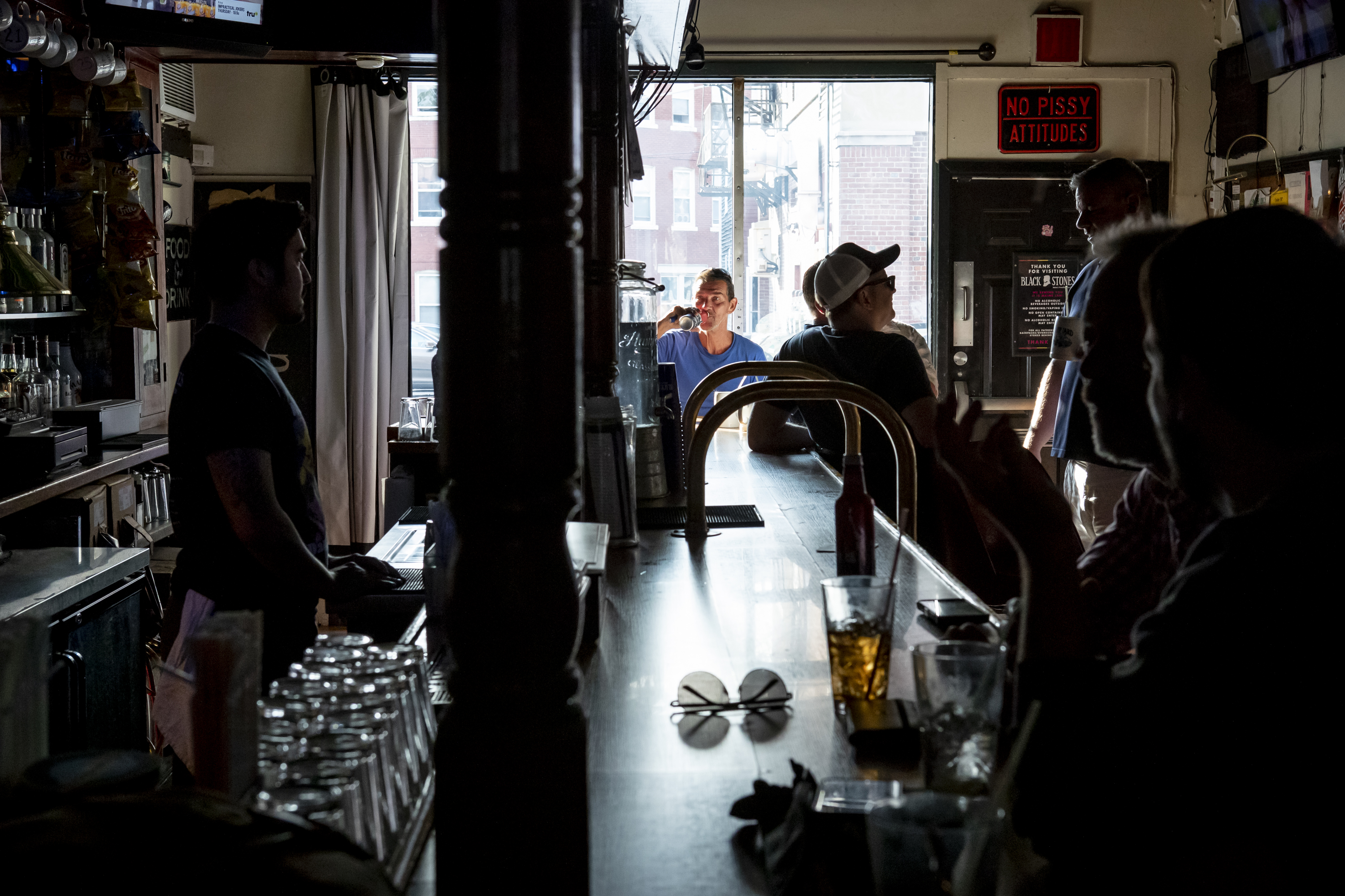 Rusty Wilcox (center) enjoyed a beer near Blackstones’ new windows.