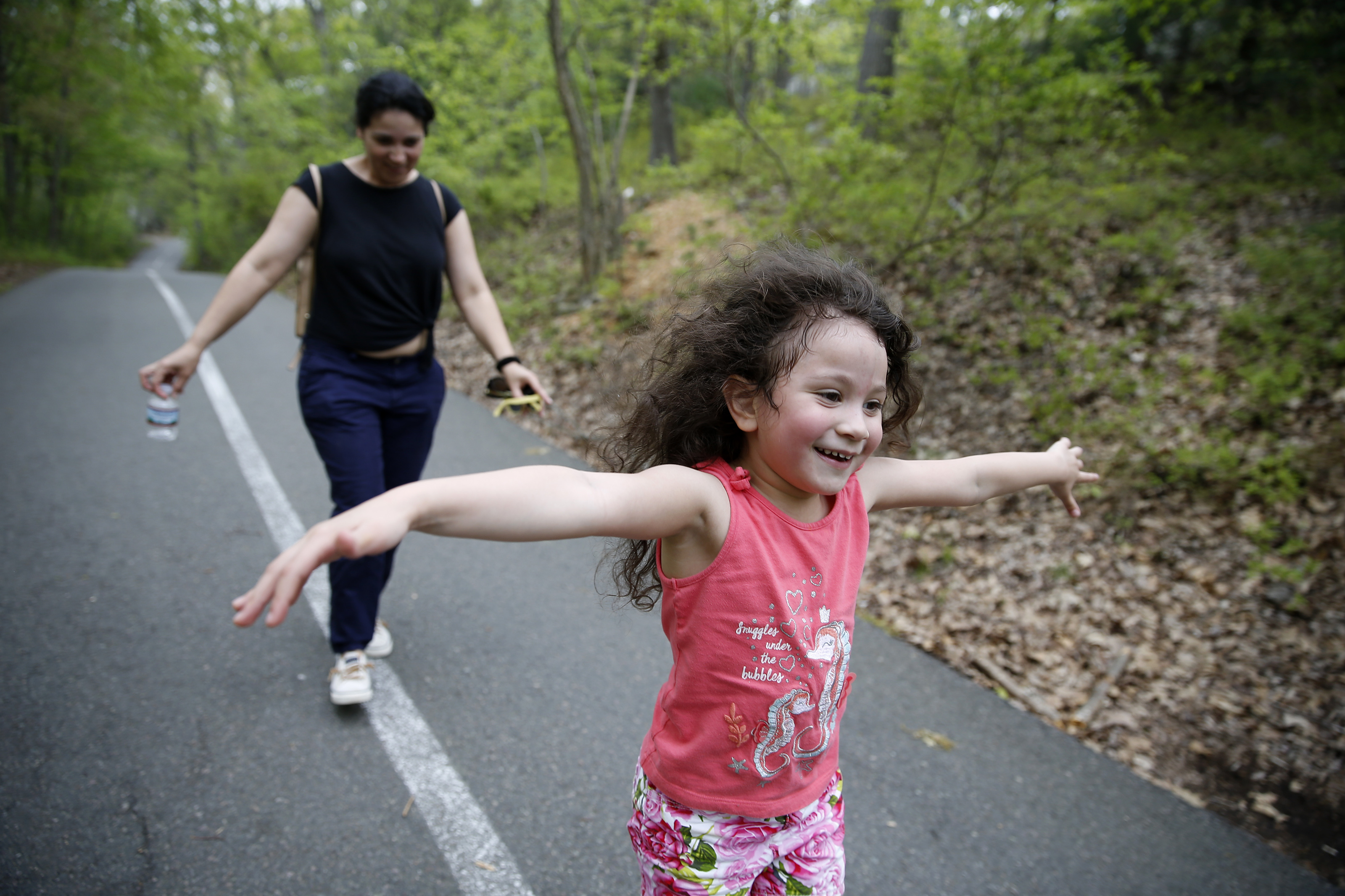 Camila ran ahead of her mom at Breakheart Reservation as the pair tried to balance on the painted line during a hike together.